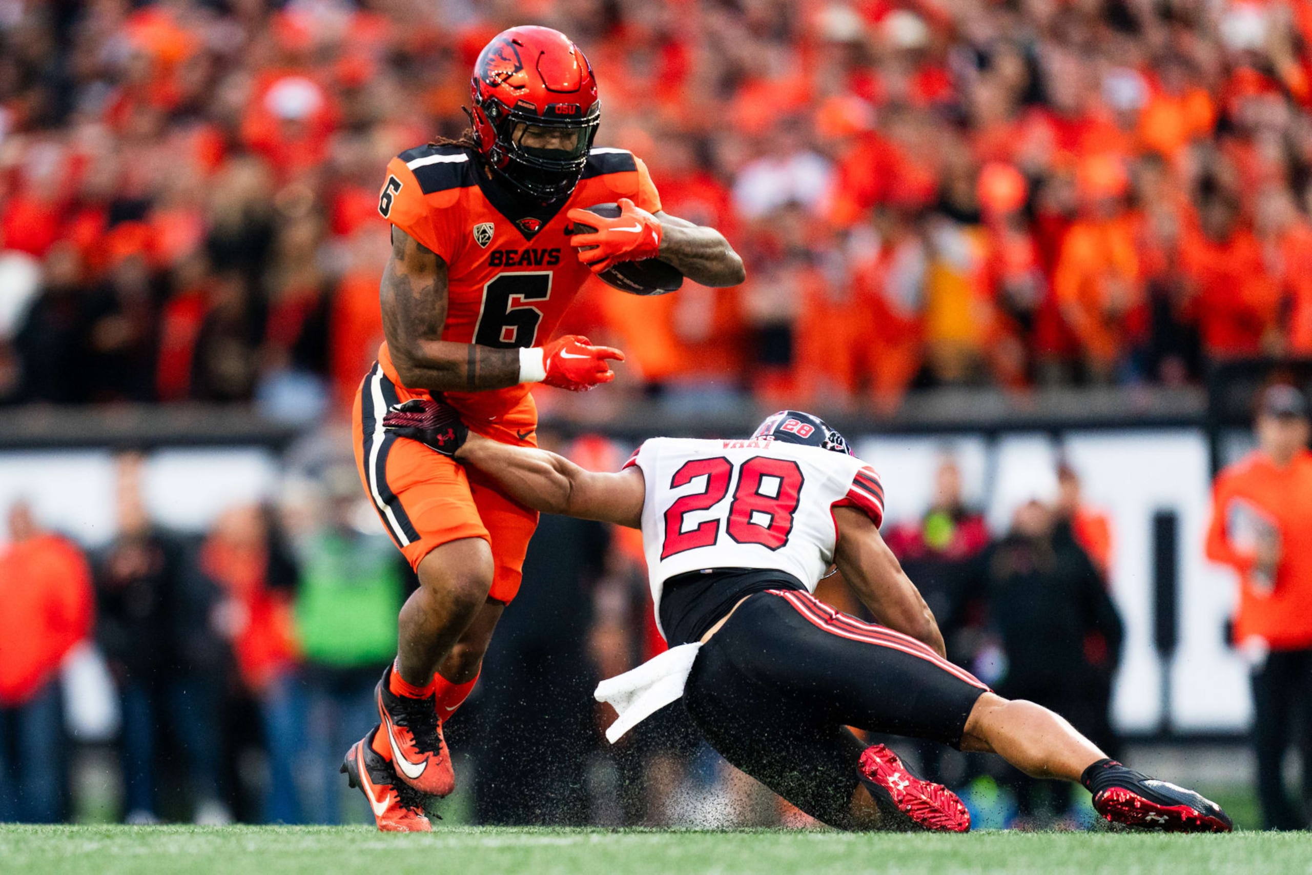 CORVALLIS, OREGON - SEPTEMBER 29:  Safety Sione Vaki #28 of the Utah Utes goes in to tackle running back Damien Martinez #6 of the Oregon State Beavers during the first half of the game at Reser Stadium on September 29, 2023 in Corvallis, Oregon. (Photo by Ali Gradischer/Getty Images)