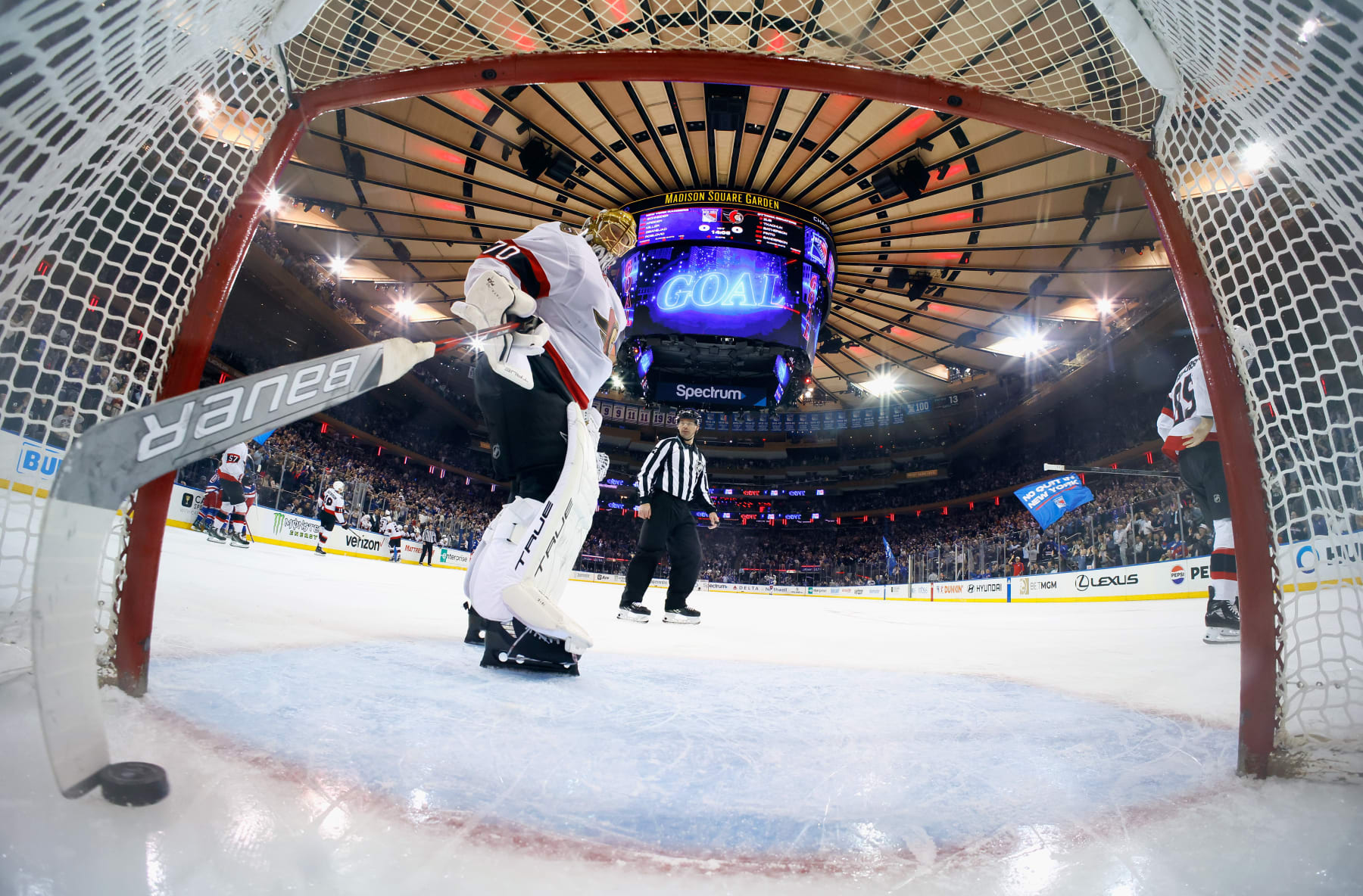 NEW YORK, NEW YORK - APRIL 15: Joonas Korpisalo #70 of the Ottawa Senators fishes the puck out of the net following the first goal of the game against the New York Rangers at Madison Square Garden on April 15, 2024 in New York City. The Rangers shut out the Senators 4-0. (Photo by Bruce Bennett/Getty Images)