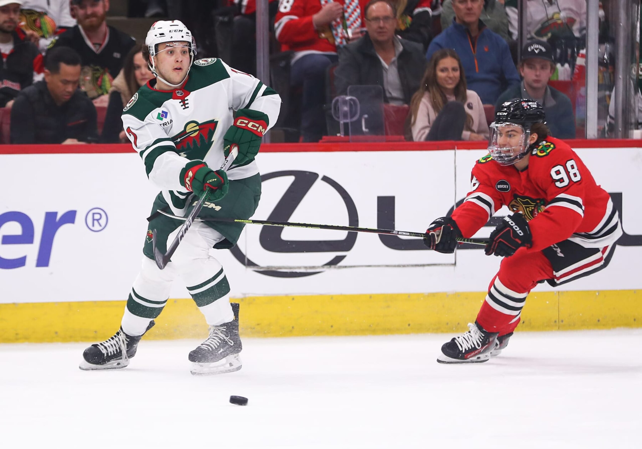 Minnesota Wild defenseman Brock Faber (left) and Chicago Blackhawks center Connor Bedard.