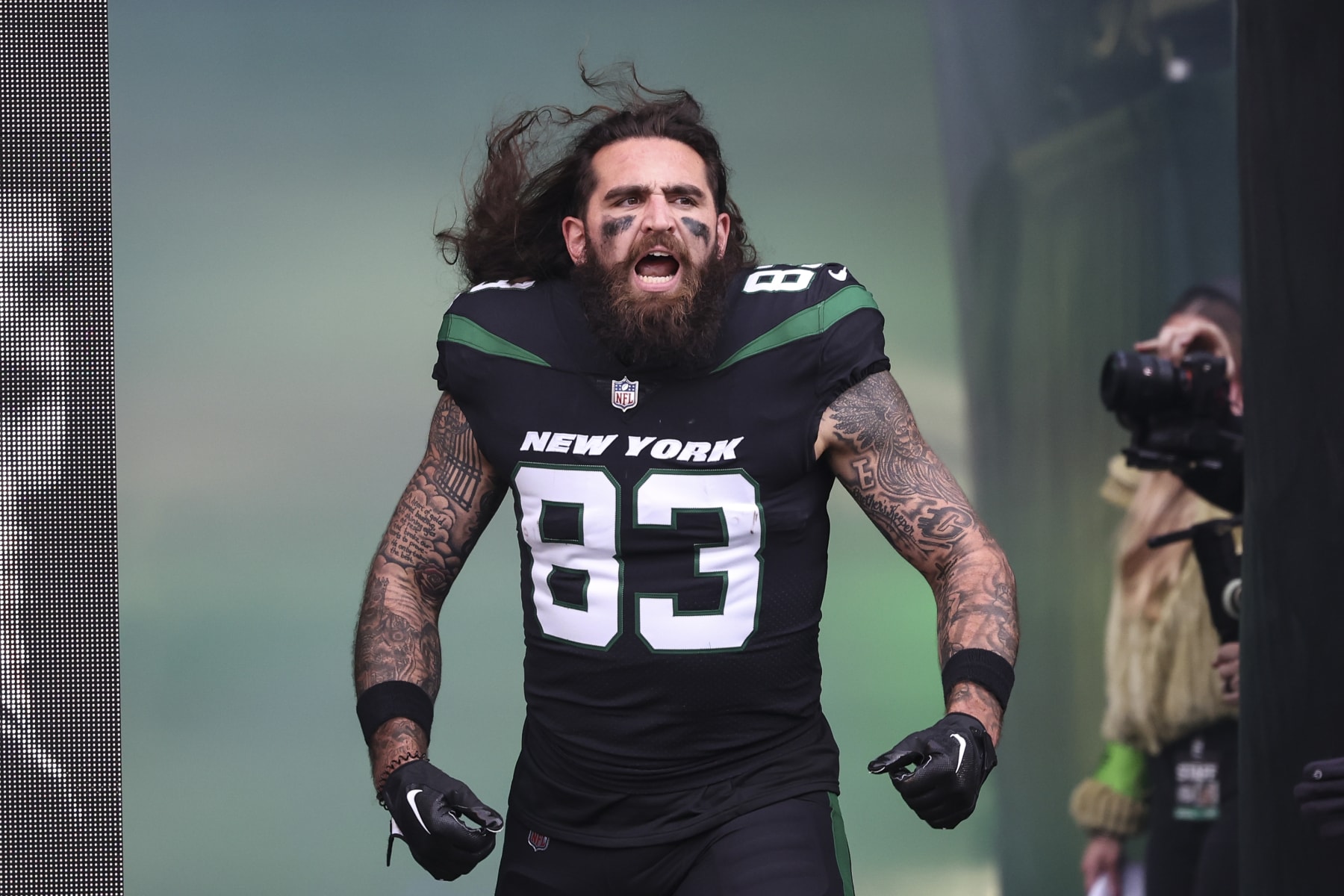 EAST RUTHERFORD, NJ - NOVEMBER 24: Tyler Conklin #83 of the New York Jets runs out of the tunnel prior to an NFL football game against the Miami Dolphins at MetLife Stadium on November 24, 2023 in East Rutherford, New Jersey. (Photo by Perry Knotts/Getty Images)