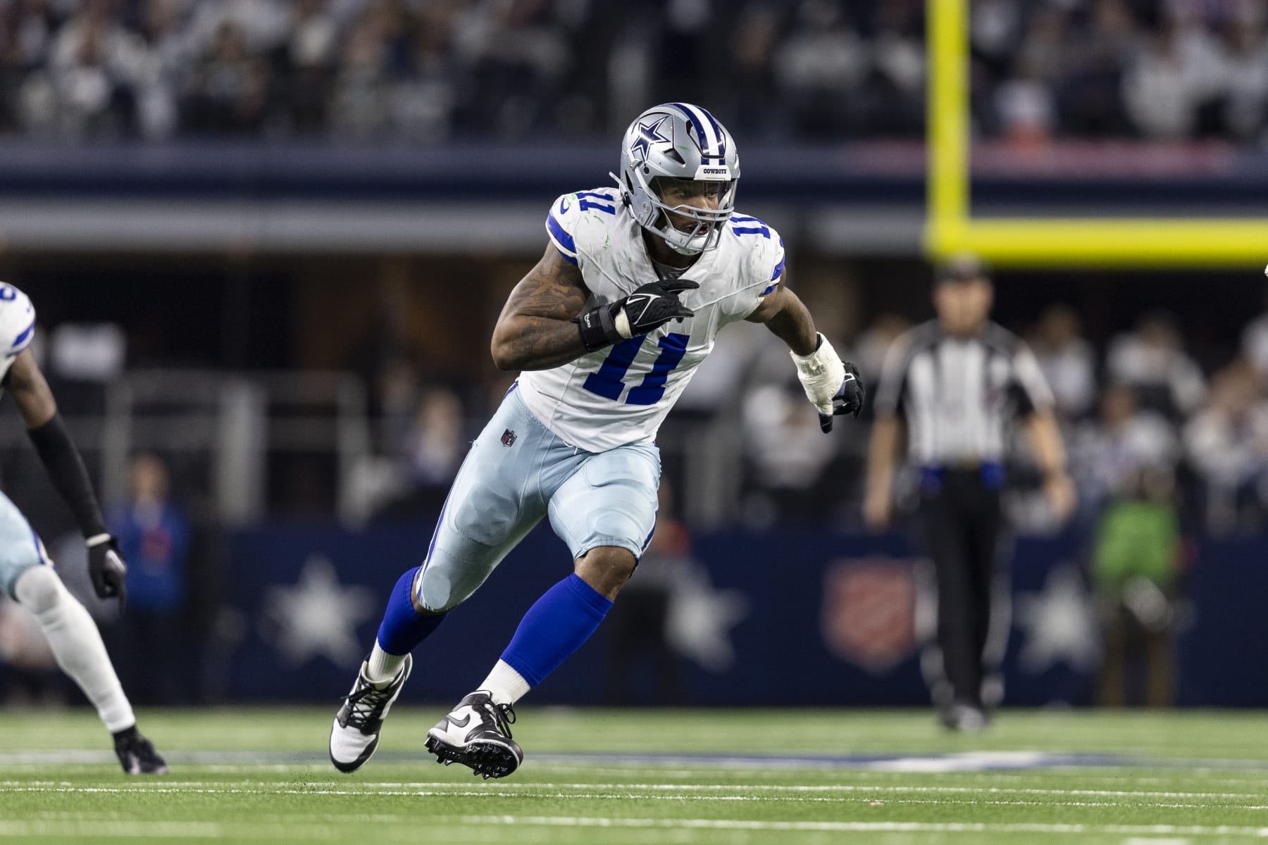 ARLINGTON, TEXAS - JANUARY 14: Micah Parsons #11 of the Dallas Cowboys runs around the edge during an NFL wild-card playoff football game between the Dallas Cowboys and the Green Bay Packers at AT&T Stadium on January 14, 2024 in Arlington, Texas. (Photo by Michael Owens/Getty Images)