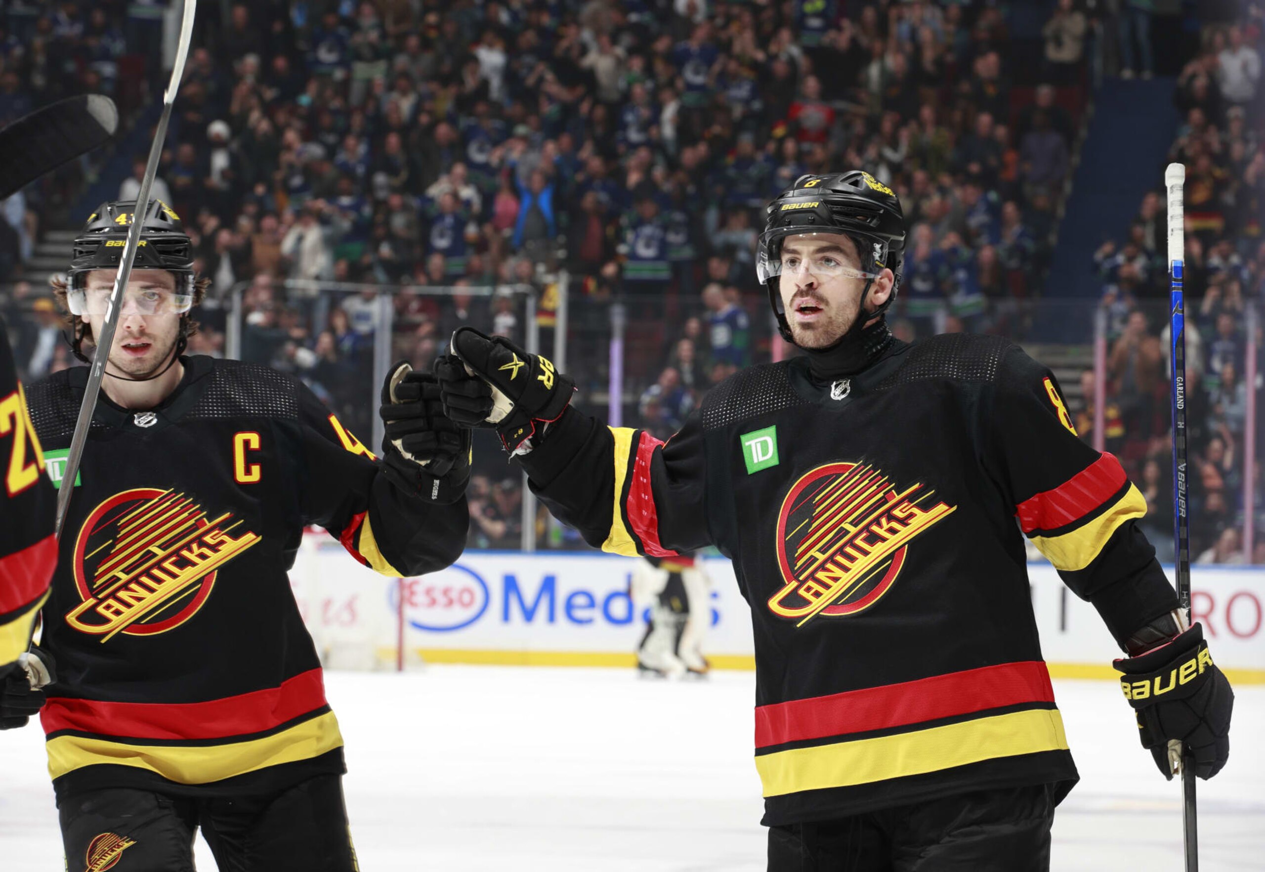 VANCOUVER, CANADA - APRIL 10: Quinn Hughes #43 and Conor Garland #8 of the Vancouver Canucks celebrate a goal during their NHL game against the Arizona Coyotes at Rogers Arena on April 10, 2024 in Vancouver, British Columbia, Canada.  (Photo by Jeff Vinnick/NHLI via Getty Images)
