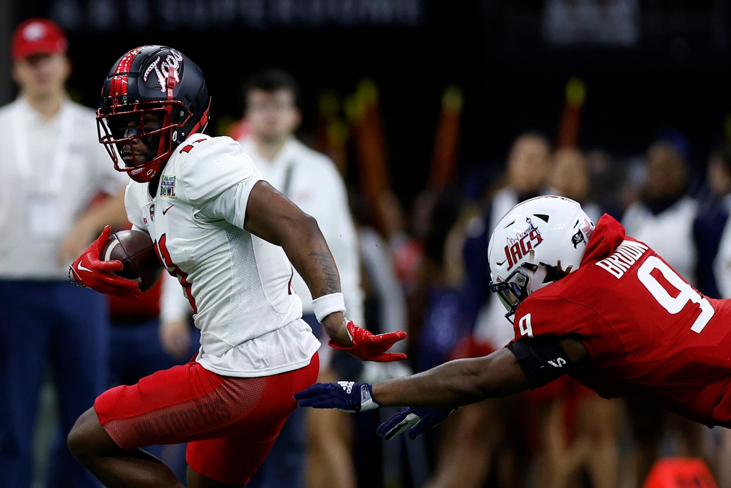 NEW ORLEANS, LOUISIANA - DECEMBER 21: Malachi Corley #11 of the Western Kentucky Hilltoppers is tackled by Ke'Shun Brown #9 of the South Alabama Jaguars during the R+L Carriers New Orleans Bowl at Caesars Superdome on December 21, 2022 in New Orleans, Louisiana. (Photo by Chris Graythen/Getty Images)