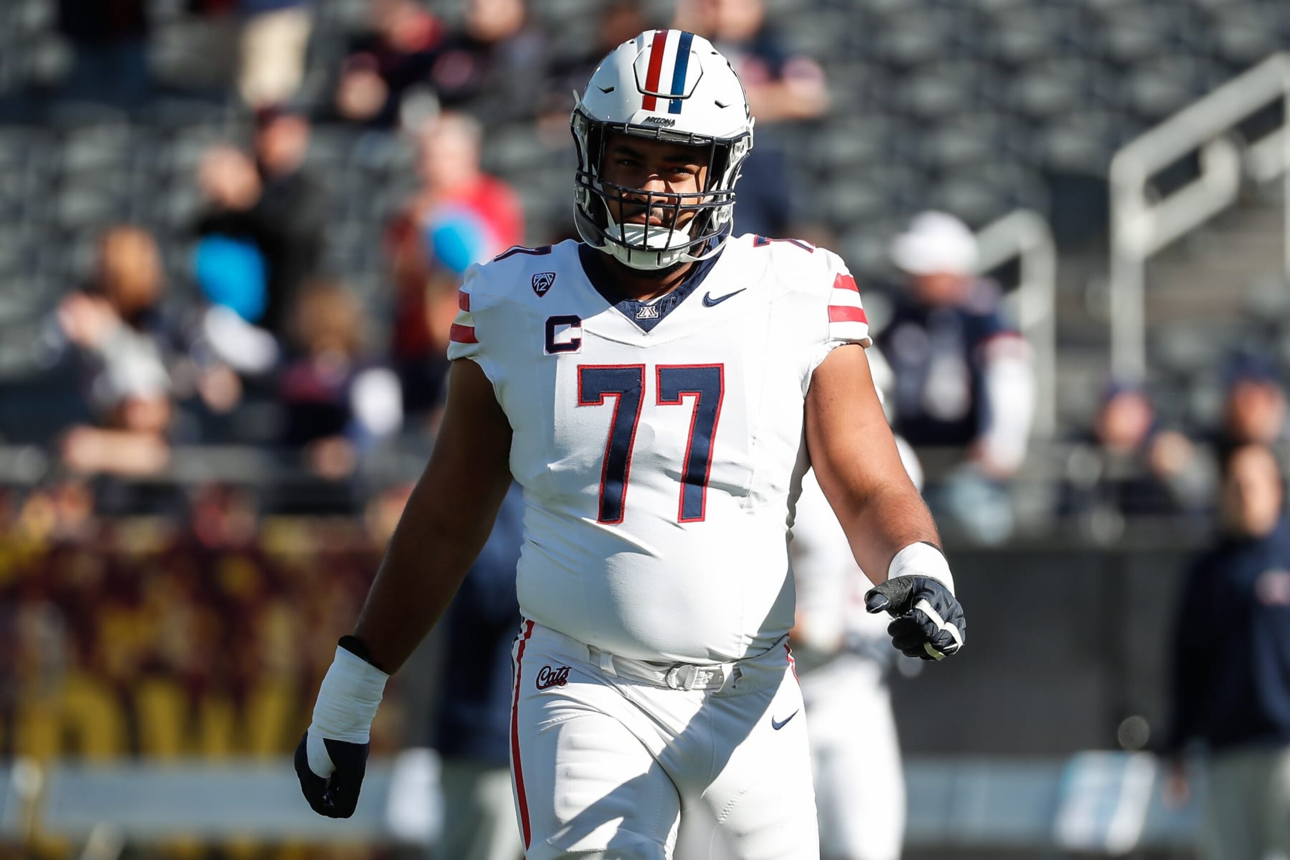 TEMPE, AZ - NOVEMBER 25: Arizona Wildcats offensive lineman Jordan Morgan (77) looks on before the college football game between the Arizona Wildcats and the Arizona State Sun Devils on November 25, 2023 at Mountain America Stadium in Tempe, Arizona. (Photo by Kevin Abele/Icon Sportswire via Getty Images) TEMPE, AZ - NOVEMBER 25: Arizona Wildcats offensive lineman Jordan Morgan (77) looks on before the college football game between the Arizona Wildcats and the Arizona State Sun Devils on November 25, 2023 at Mountain America Stadium in Tempe, Arizona. (Photo by Kevin Abele/Icon Sportswire via Getty Images)
