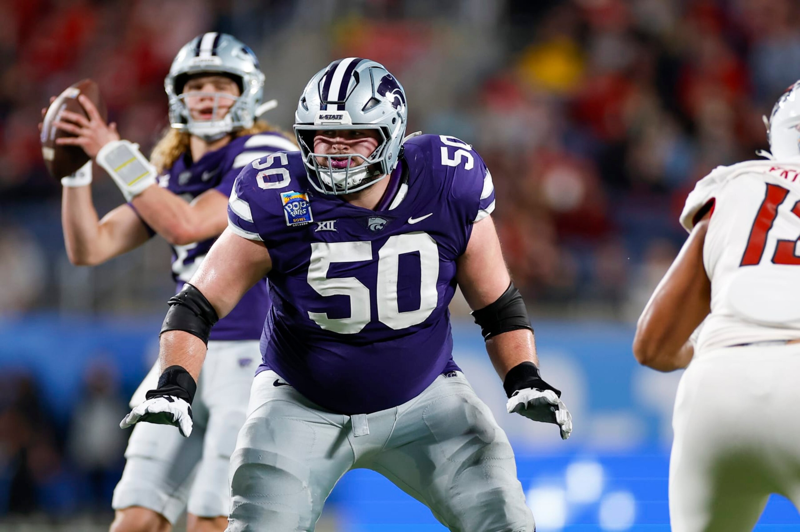 ORLANDO, FL - DECEMBER 28: Kansas State Wildcats offensive lineman Cooper Beebe (50) blocks during the game between the North Carolina State Wolfpack and the Kansas State Wildcats on December 28, 2023 at Camping World Stadium in Orlando, Fl. (Photo by David Rosenblum/Icon Sportswire via Getty Images)