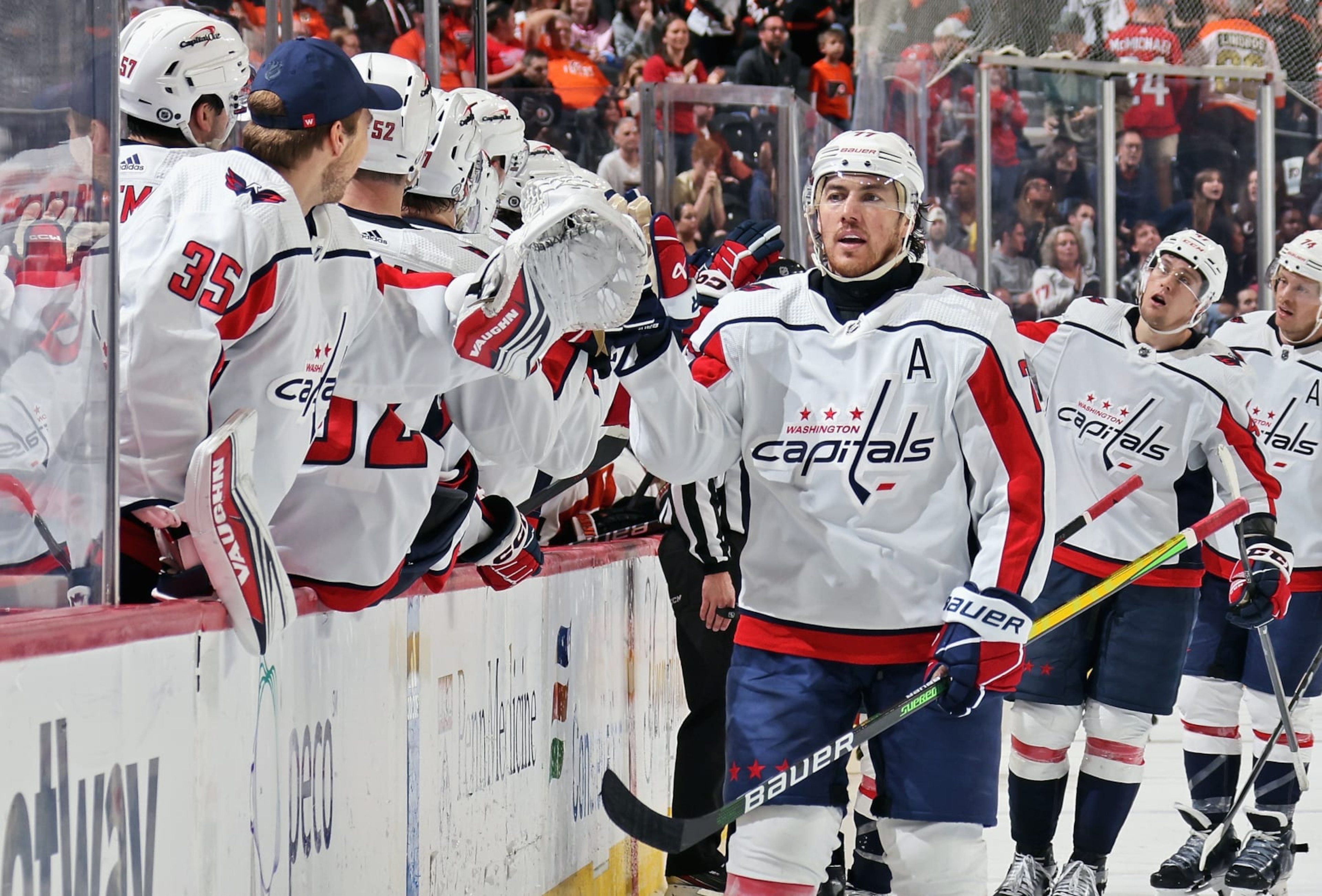 PHILADELPHIA, PENNSYLVANIA - APRIL 16: T.J. Oshie #77 of the Washington Capitals celebrates his third period empty-net goal against the Philadelphia Flyers with his teammates on the bench at the Wells Fargo Center on April 16, 2024 in Philadelphia, Pennsylvania. With tonight's win, the Capitals have reached the NHL playoffs. (Photo by Len Redkoles/NHLI via Getty Images)
