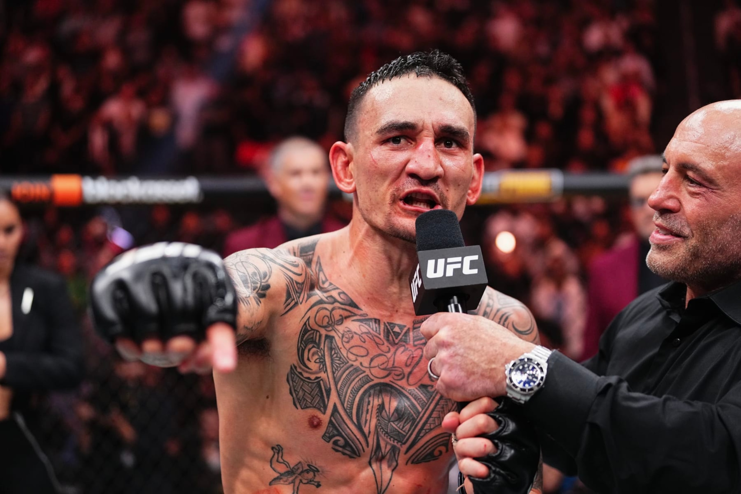 LAS VEGAS, NEVADA - APRIL 13: (R-L) Joe Rogan interviews Max Holloway in the BMF championship fight during the UFC 300 event at T-Mobile Arena on April 13, 2024 in Las Vegas, Nevada.  (Photo by Jeff Bottari/Zuffa LLC via Getty Images)