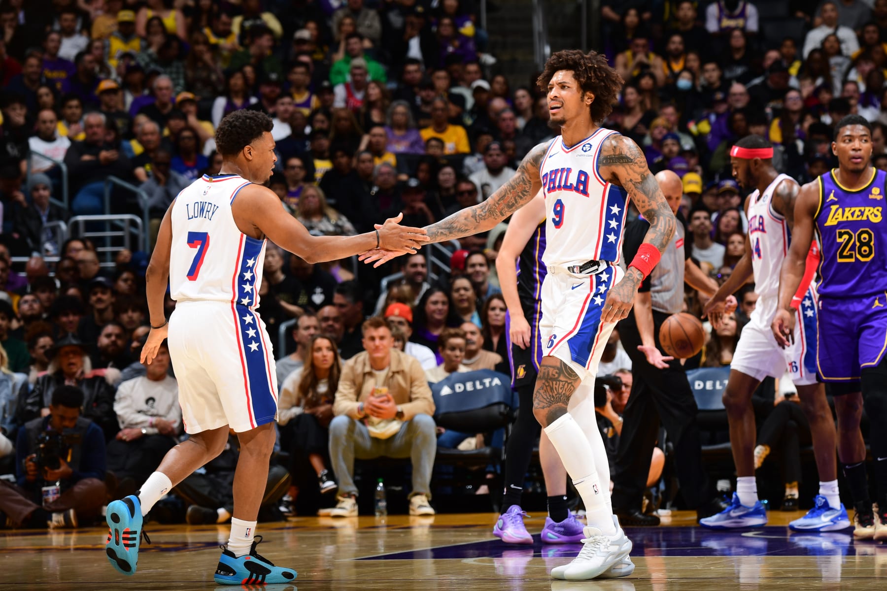 LOS ANGELES, CA - MARCH 22: Kelly Oubre Jr. #9 and Kyle Lowry #7 of the Philadelphia 76ers high five during the game against the Los Angeles Lakers on March 22, 2024 at Crypto.Com Arena in Los Angeles, California. NOTE TO USER: User expressly acknowledges and agrees that, by downloading and/or using this Photograph, user is consenting to the terms and conditions of the Getty Images License Agreement. Mandatory Copyright Notice: Copyright 2024 NBAE (Photo by Adam Pantozzi/NBAE via Getty Images)