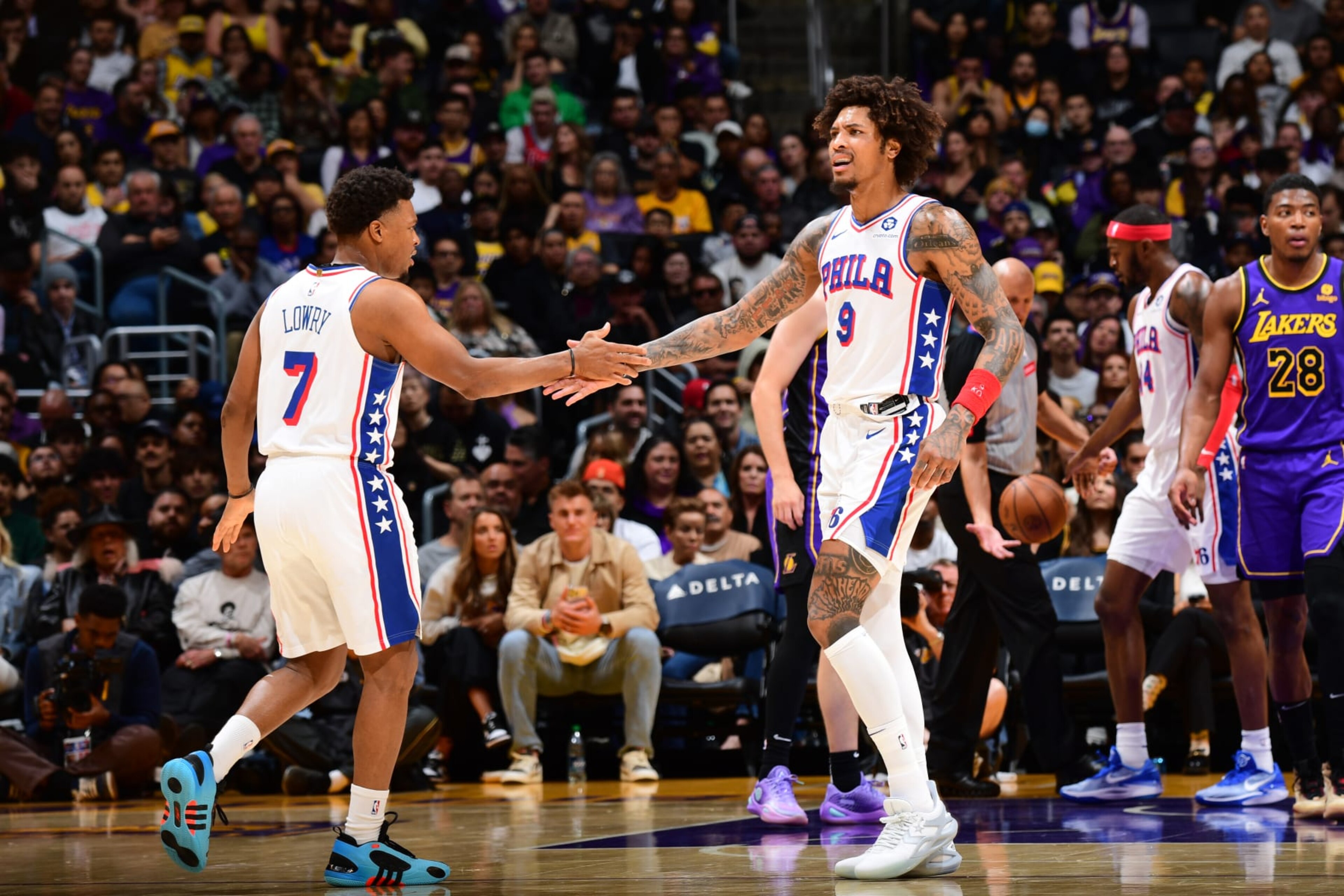 LOS ANGELES, CA - MARCH 22: Kelly Oubre Jr. #9 and Kyle Lowry #7 of the Philadelphia 76ers high five during the game against the Los Angeles Lakers on March 22, 2024 at Crypto.Com Arena in Los Angeles, California. NOTE TO USER: User expressly acknowledges and agrees that, by downloading and/or using this Photograph, user is consenting to the terms and conditions of the Getty Images License Agreement. Mandatory Copyright Notice: Copyright 2024 NBAE (Photo by Adam Pantozzi/NBAE via Getty Images)