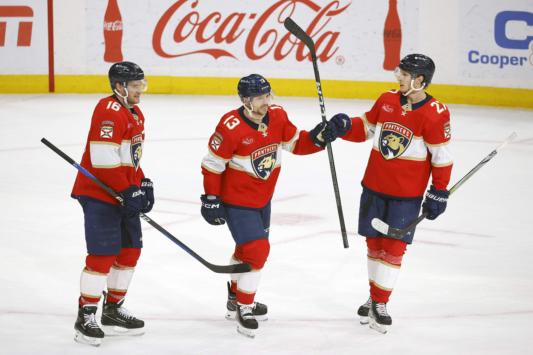SUNRISE, FLORIDA - APRIL 16: Sam Reinhart #13 of the Florida Panthers celebrates his empty net goal with teammates Aleksander Barkov #16 and Eetu Luostarinen #27 against the Toronto Maple Leafs at the Amerant Bank Arena on April 16, 2024 in Sunrise, Florida. (Photo by Eliot J. Schechter/NHLI via Getty Images)