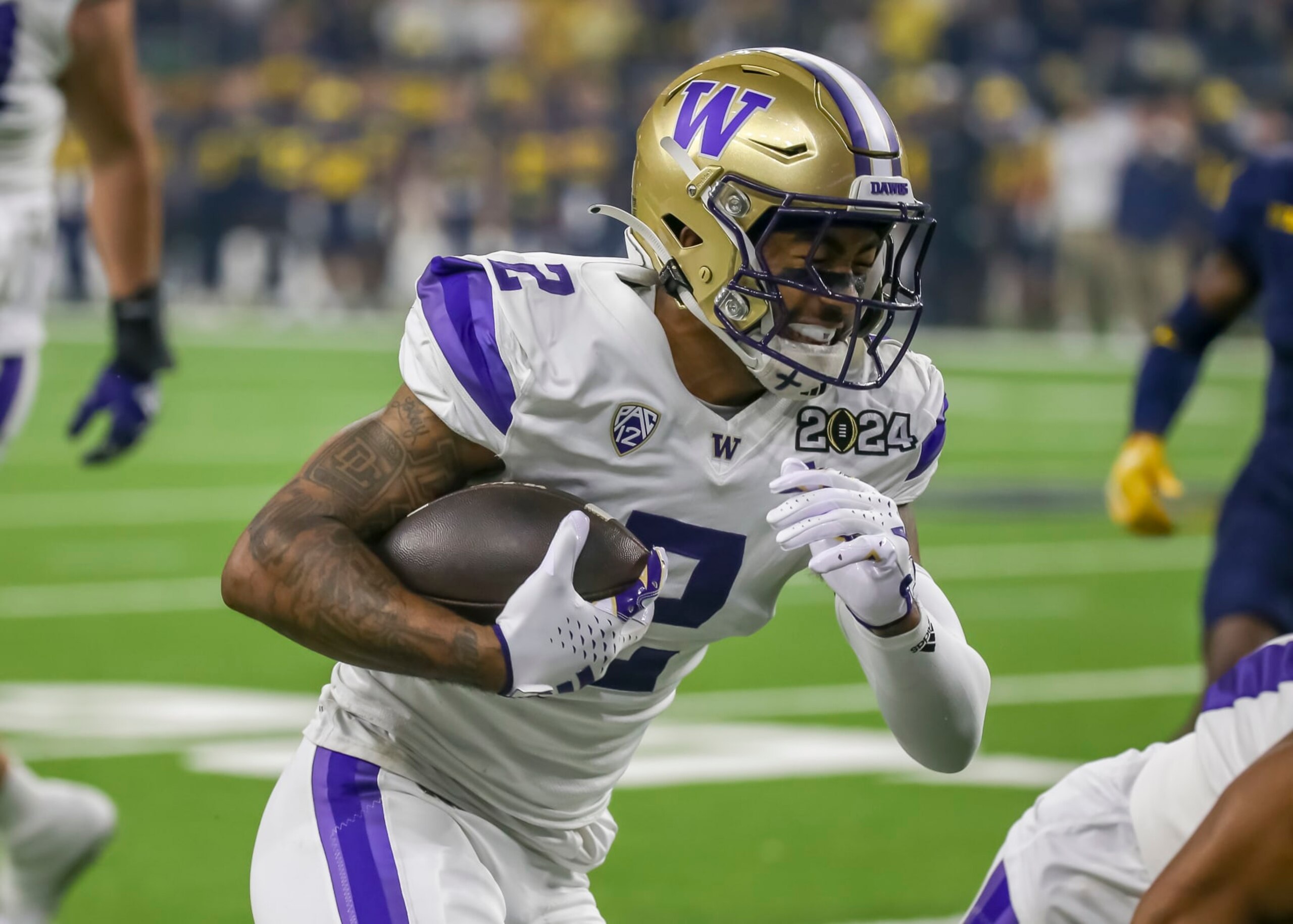 HOUSTON, TX - JANUARY 08:  Washington Huskies wide receiver Ja'Lynn Polk (2) carries the ball in the first quarter during the CFP National Championship game between the Michigan Wolverines and Washington Huskies on January 8, 2024 at NRG Stadium in Houston, Texas.  (Photo by Leslie Plaza Johnson/Icon Sportswire via Getty Images)