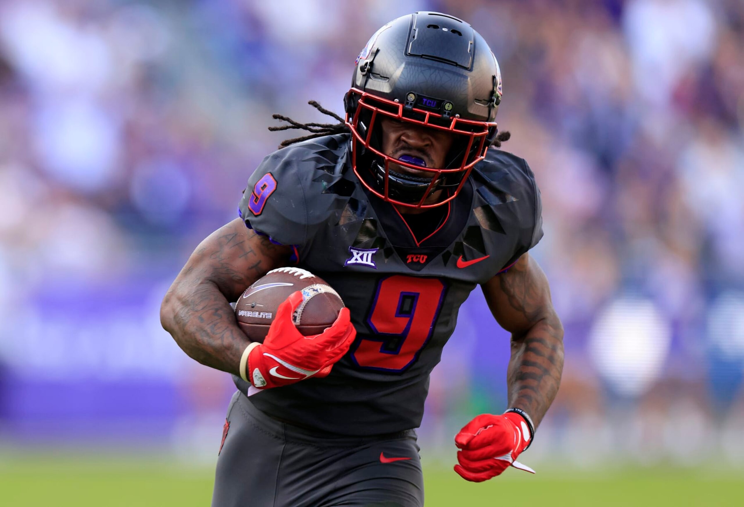 FORT WORTH, TX - NOVEMBER 18: Emani Bailey #9 of the TCU Horned Frogs carries the ball in for a touchdown against the Baylor Bears during the first half at Amon G. Carter Stadium on November 18, 2023 in Fort Worth, Texas. (Photo by Ron Jenkins/Getty Images)