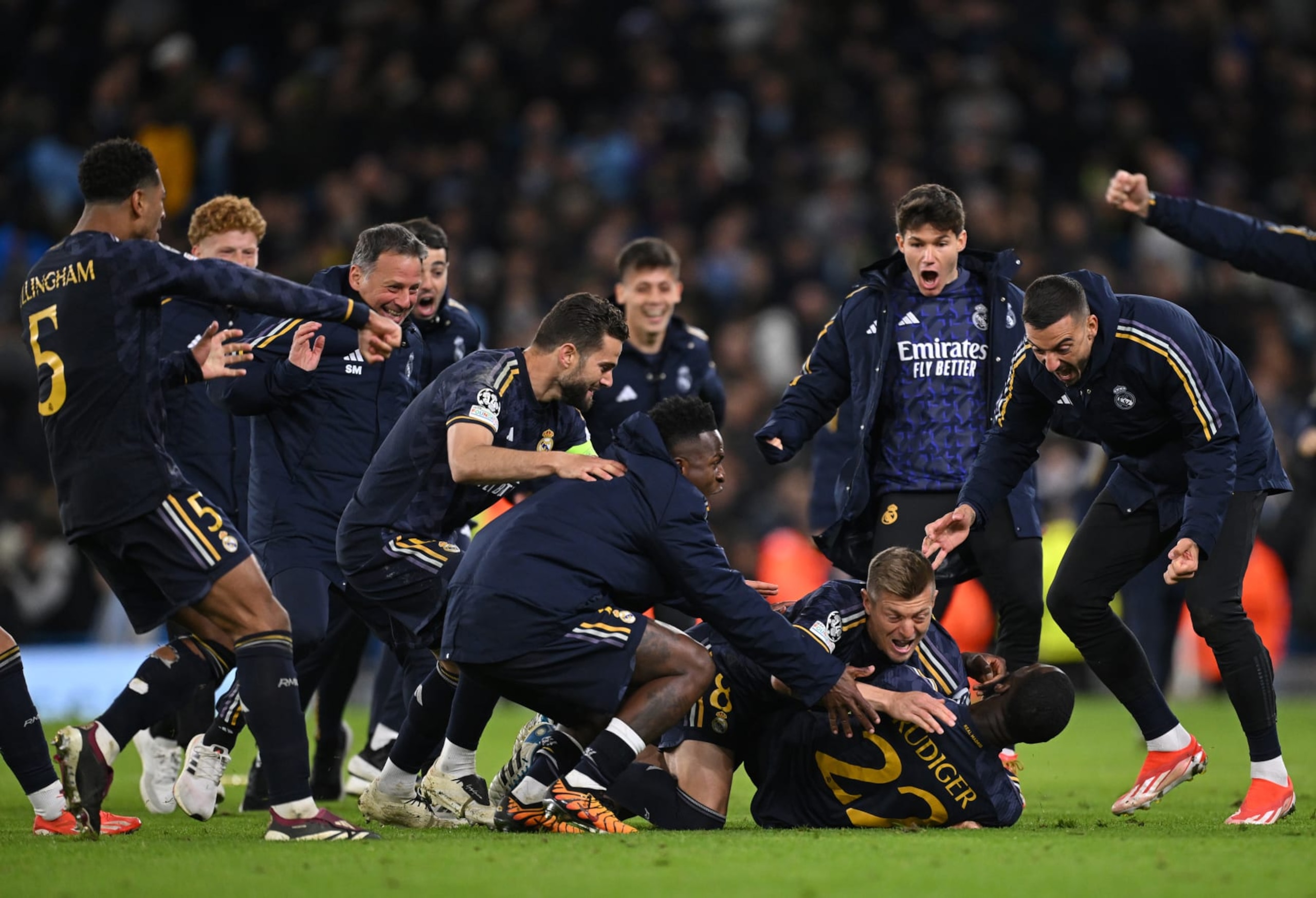 MANCHESTER, ENGLAND - APRIL 17: Antonio Ruediger of Real Madrid celebrates with teammates after scoring the sides winning penalty in the penalty shoot out during the UEFA Champions League quarter-final second leg match between Manchester City and Real Madrid CF at Etihad Stadium on April 17, 2024 in Manchester, England. (Photo by Stu Forster/Getty Images)