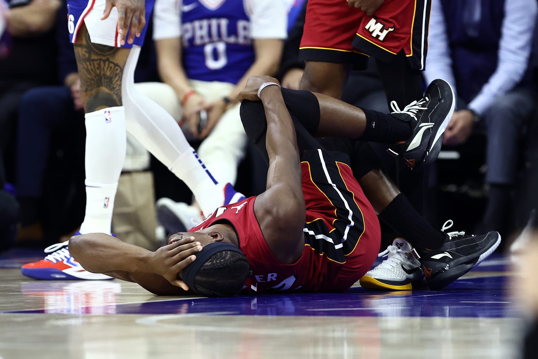 PHILADELPHIA, PENNSYLVANIA - APRIL 17: Jimmy Butler #22 of the Miami Heat reacts to an injury during the first quarter against the Philadelphia 76ers during the Eastern Conference Play-In Tournament at the Wells Fargo Center on April 17, 2024 in Philadelphia, Pennsylvania. NOTE TO USER: User expressly acknowledges and agrees that, by downloading and or using this photograph, User is consenting to the terms and conditions of the Getty Images License Agreement. (Photo by Tim Nwachukwu/Getty Images)