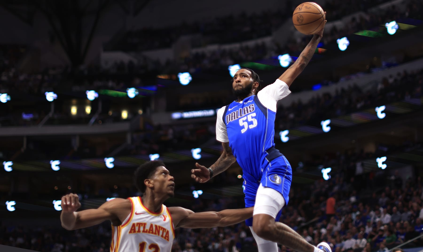 DALLAS, TX - APRIL 04: Derrick Jones Jr. #55 of the Dallas Mavericks goes up for a slam dunk against De'Andre Hunter #12 of the Atlanta Hawks in the second half at American Airlines Center on April 4, 2024 in Dallas, Texas. NOTE TO USER: User expressly acknowledges and agrees that, by downloading and or using this photograph, User is consenting to the terms and conditions of the Getty Images License Agreement. (Photo by Ron Jenkins/Getty Images)