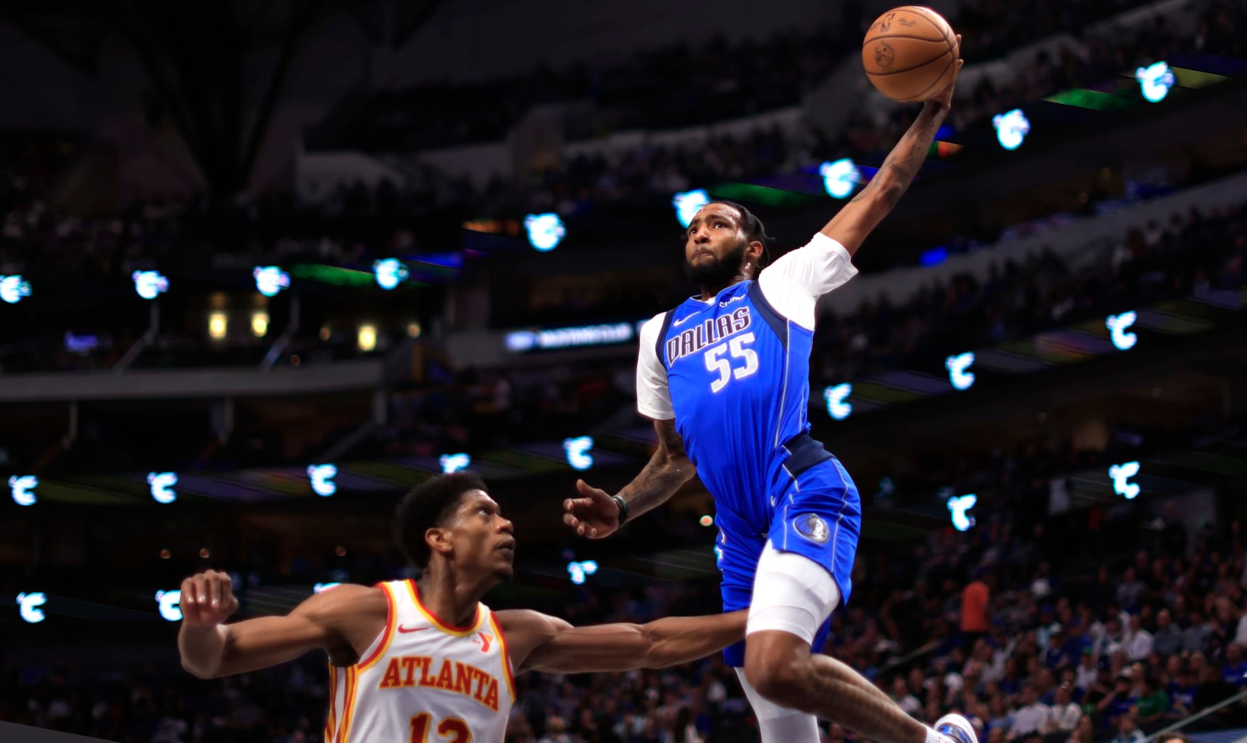 DALLAS, TX - APRIL 04: Derrick Jones Jr. #55 of the Dallas Mavericks goes up for a slam dunk against De'Andre Hunter #12 of the Atlanta Hawks in the second half at American Airlines Center on April 4, 2024 in Dallas, Texas. NOTE TO USER: User expressly acknowledges and agrees that, by downloading and or using this photograph, User is consenting to the terms and conditions of the Getty Images License Agreement. (Photo by Ron Jenkins/Getty Images) DALLAS, TX - APRIL 04: Derrick Jones Jr. #55 of the Dallas Mavericks goes up for a slam dunk against De'Andre Hunter #12 of the Atlanta Hawks in the second half at American Airlines Center on April 4, 2024 in Dallas, Texas. NOTE TO USER: User expressly acknowledges and agrees that, by downloading and or using this photograph, User is consenting to the terms and conditions of the Getty Images License Agreement. (Photo by Ron Jenkins/Getty Images)