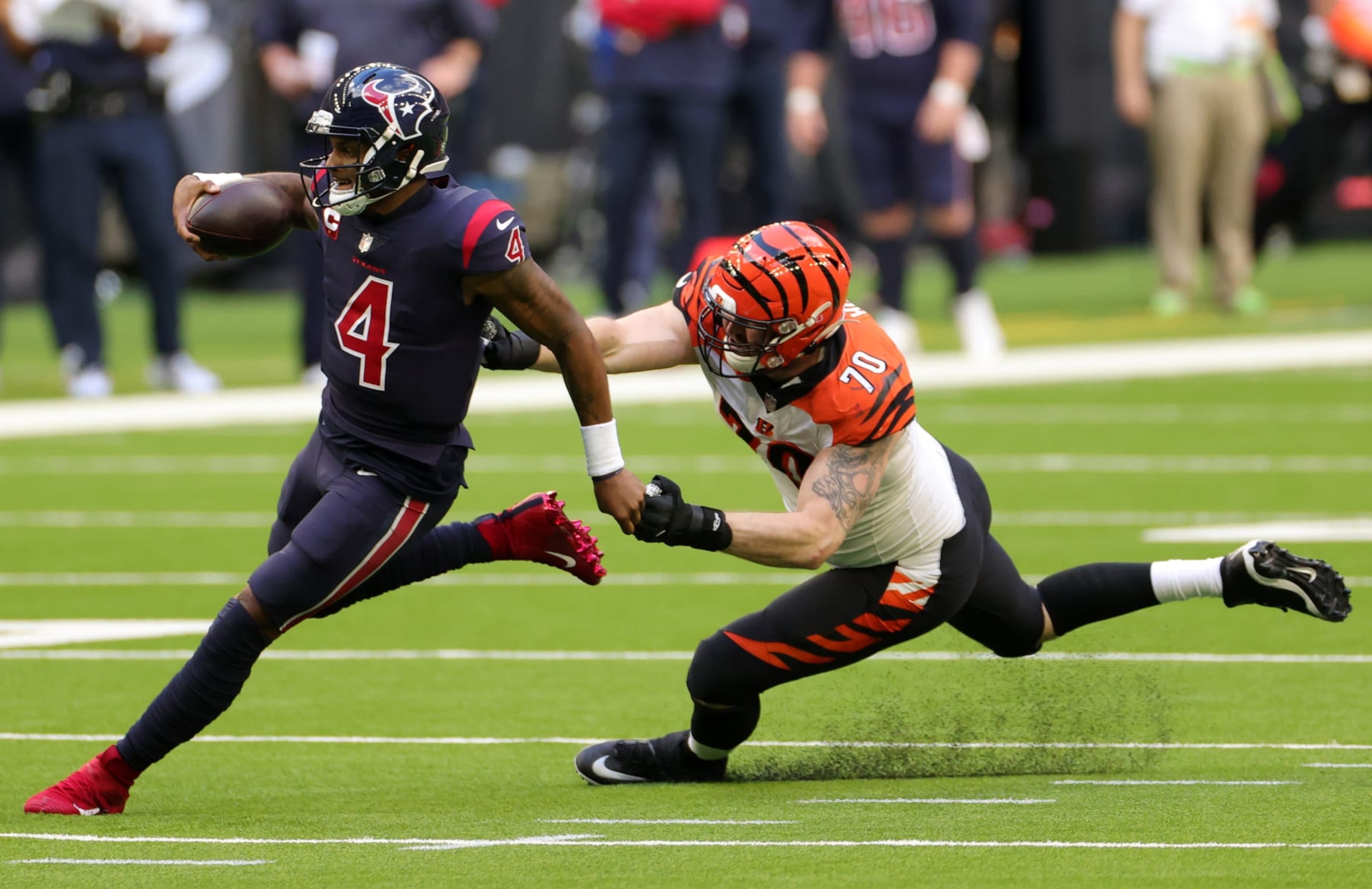 HOUSTON, TEXAS - DECEMBER 27: Quarterback Deshaun Watson #4 of the Houston Texans scrambles against defensive end Margus Hunt #70 of the Cincinnati Bengals during the fourth quarter of the game at NRG Stadium on December 27, 2020 in Houston, Texas. (Photo by Carmen Mandato/Getty Images) HOUSTON, TEXAS - DECEMBER 27: Quarterback Deshaun Watson #4 of the Houston Texans scrambles against defensive end Margus Hunt #70 of the Cincinnati Bengals during the fourth quarter of the game at NRG Stadium on December 27, 2020 in Houston, Texas. (Photo by Carmen Mandato/Getty Images)