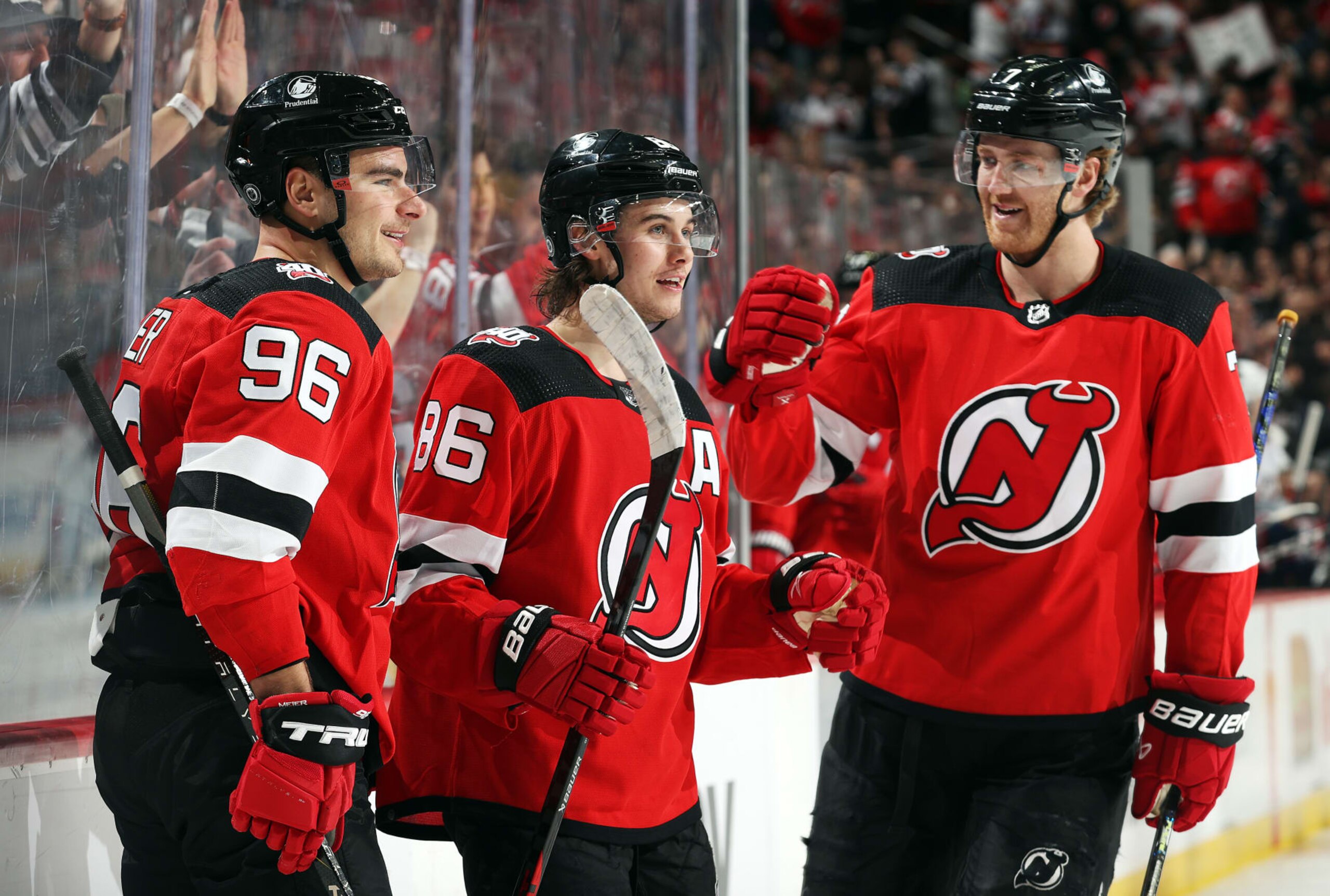 NEWARK, NEW JERSEY - APRIL 06:  Jack Hughes #86 of the New Jersey Devils is congratulated by teammates Timo Meier #96 and Dougie Hamilton #7 after scoring during the 2nd period of the game against the Columbus Blue Jackets at Prudential Center on April 06, 2023 in Newark, New Jersey. (Photo by Jamie Squire/Getty Images)
