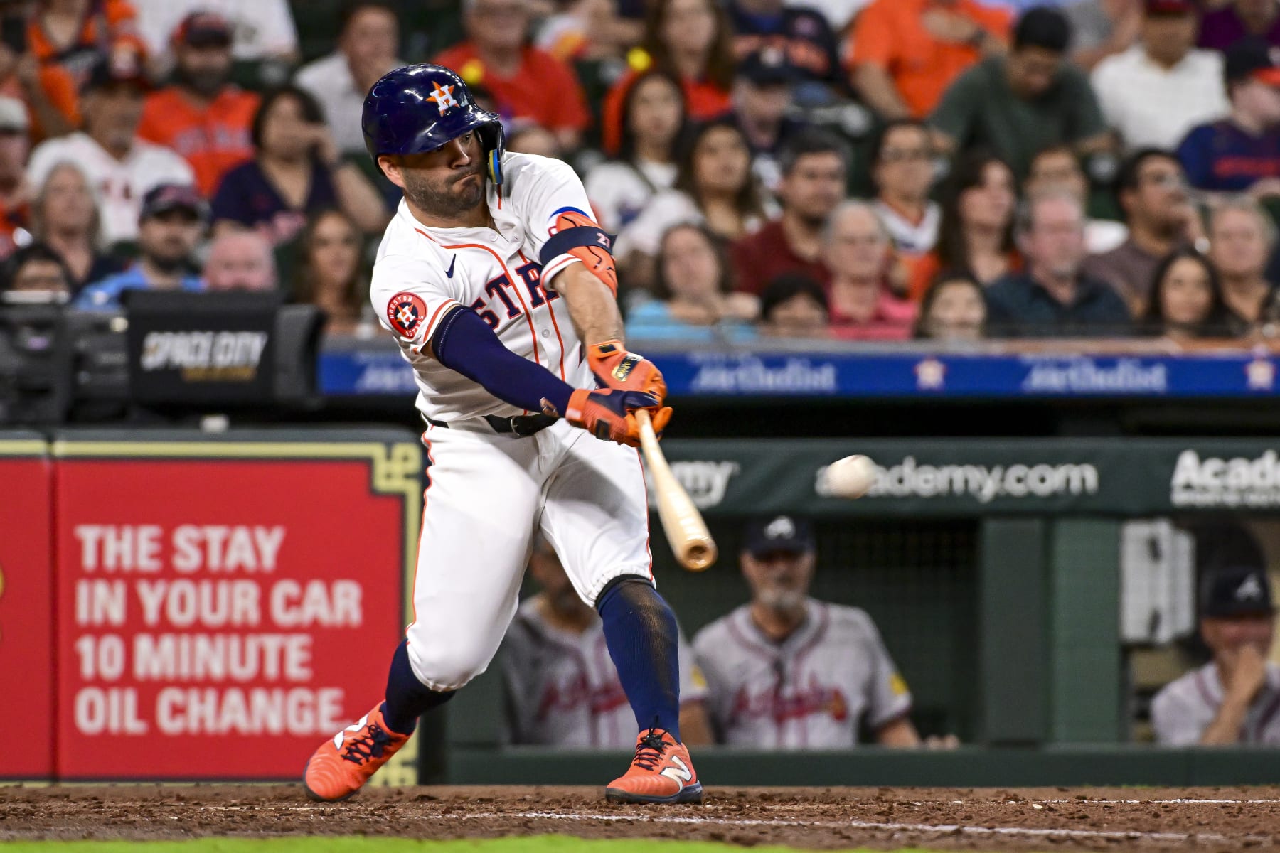 HOUSTON, TEXAS - APRIL 17: Jose Altuve #27 of the Houston Astros hits a single for an RBI in the fifth inning against the Atlanta Braves at Minute Maid Park on April 17, 2024 in Houston, Texas. (Photo by Logan Riely/Getty Images)