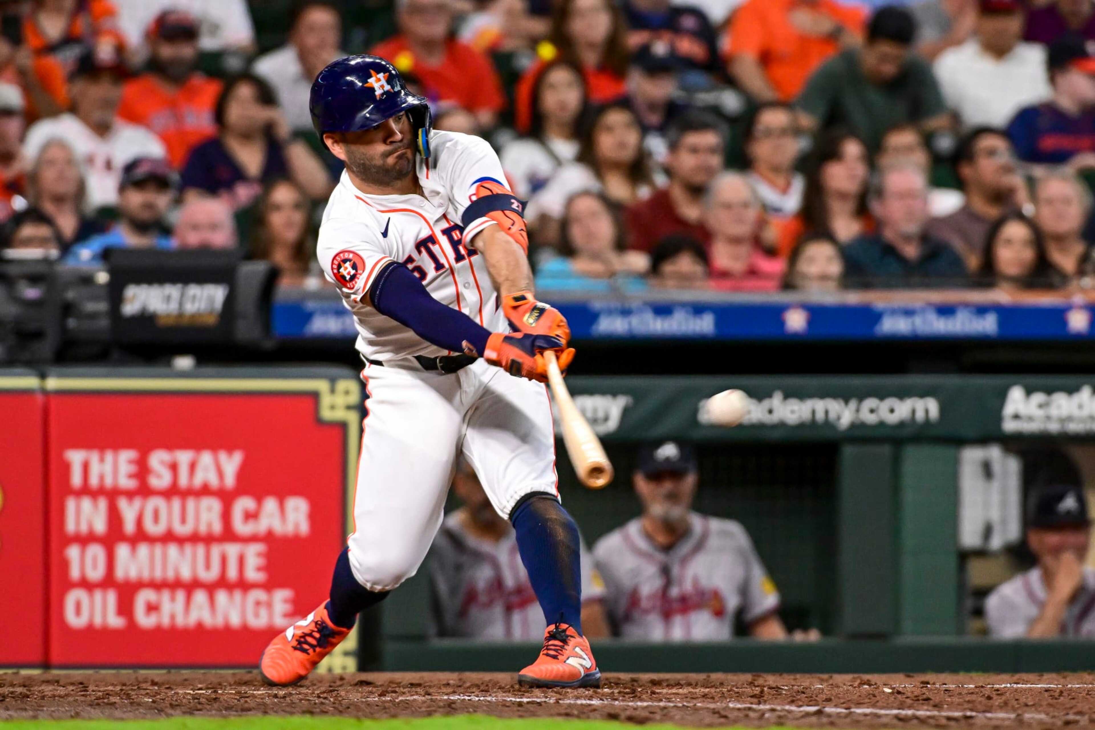 HOUSTON, TEXAS - APRIL 17: Jose Altuve #27 of the Houston Astros hits a single for an RBI in the fifth inning against the Atlanta Braves at Minute Maid Park on April 17, 2024 in Houston, Texas. (Photo by Logan Riely/Getty Images)