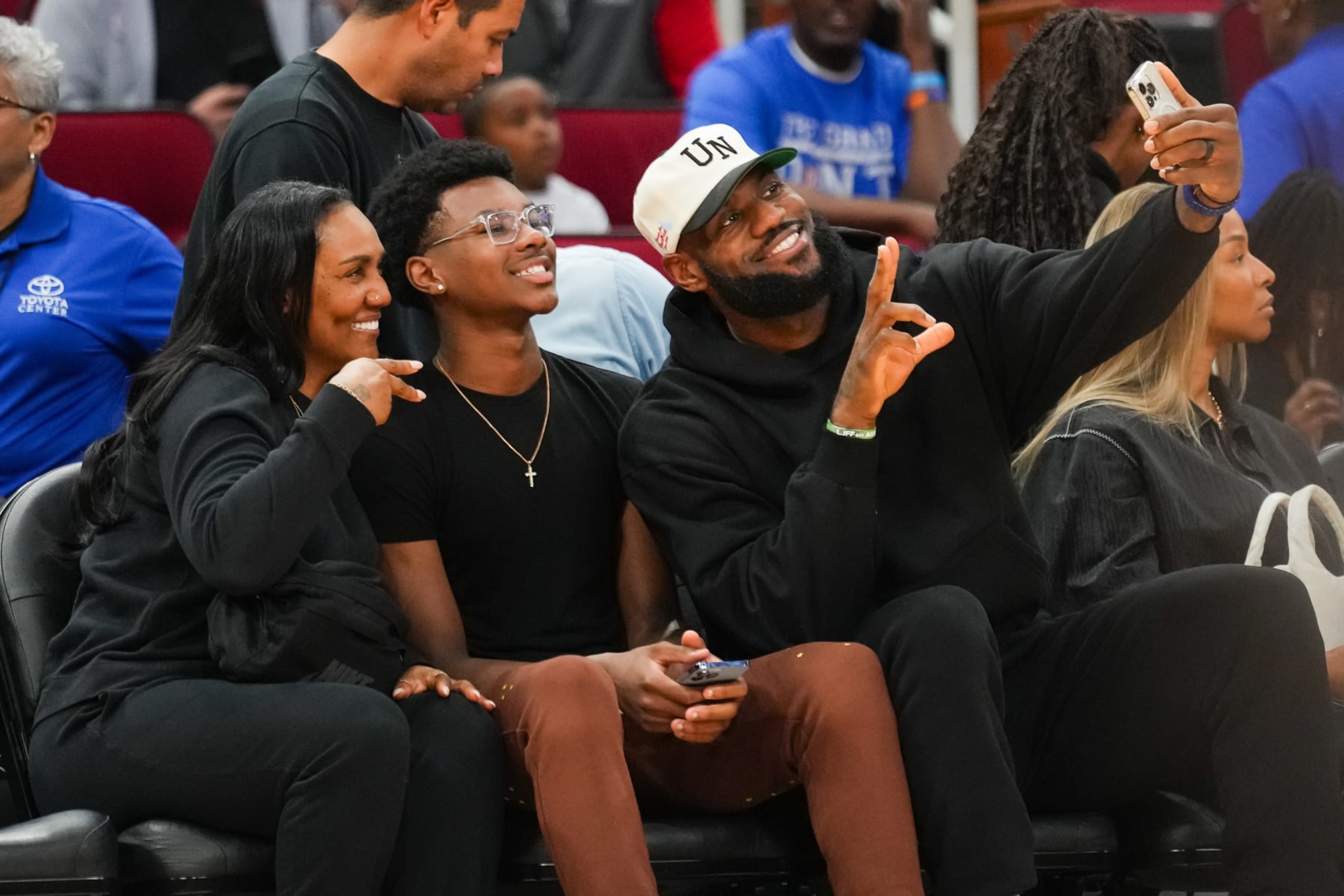 HOUSTON, TEXAS - MARCH 28: Lebron James of the Los Angeles Lakers takes a selfie with his mother Gloria James and son Bryce James during the 2023 McDonald's High School All-American Games at Toyota Center on March 28, 2023 in Houston, Texas. (Photo by Alex Bierens de Haan/Getty Images)