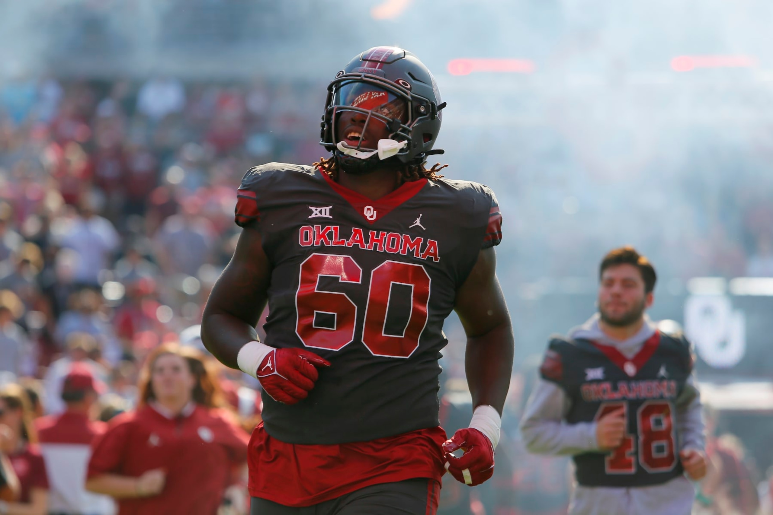NORMAN, OK - OCTOBER 15: Left tackle Tyler Guyton #60 of the Oklahoma Sooners looks up at a banner as he runs onto the field for a game against the Kansas Jayhawks at Gaylord Family Oklahoma Memorial Stadium on October 15, 2022 in Norman, Oklahoma. Oklahoma won 52-42. (Photo by Brian Bahr/Getty Images) NORMAN, OK - OCTOBER 15: Left tackle Tyler Guyton #60 of the Oklahoma Sooners looks up at a banner as he runs onto the field for a game against the Kansas Jayhawks at Gaylord Family Oklahoma Memorial Stadium on October 15, 2022 in Norman, Oklahoma. Oklahoma won 52-42. (Photo by Brian Bahr/Getty Images)