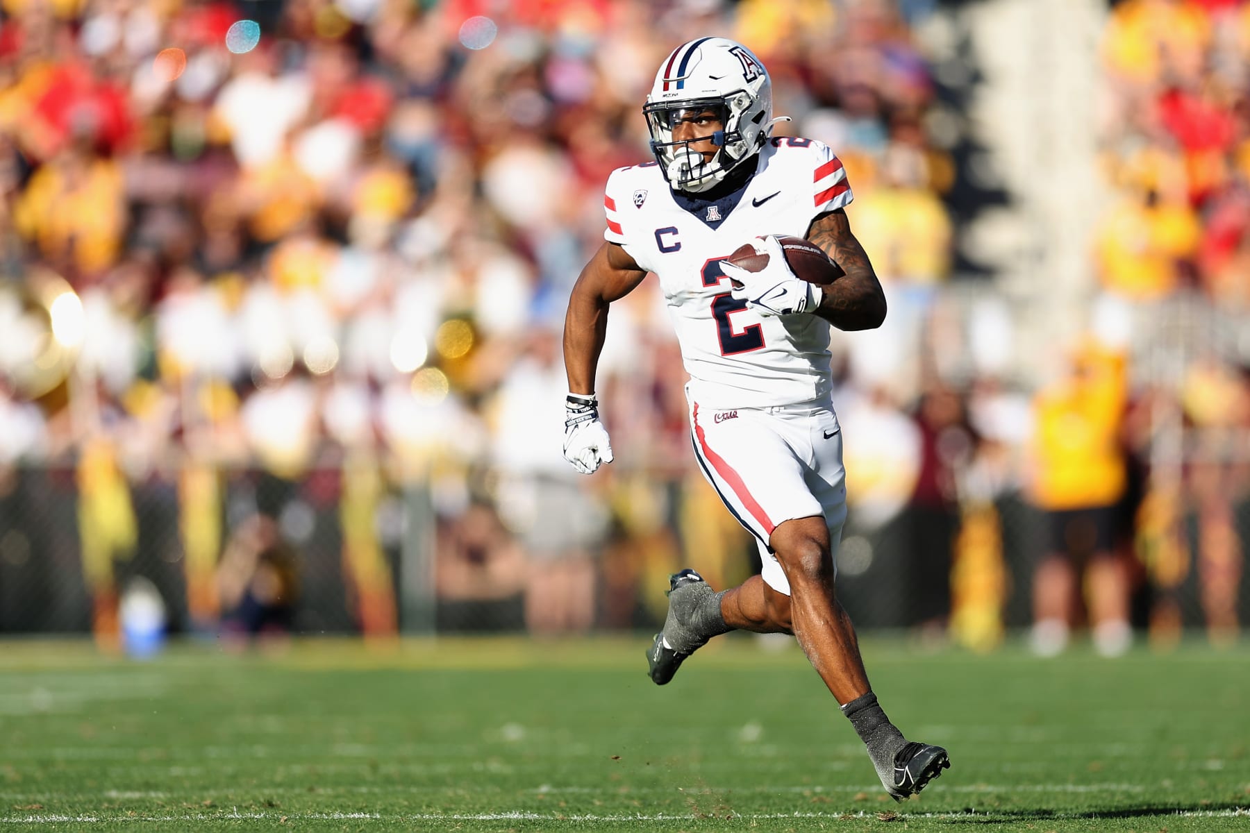 TEMPE, ARIZONA - NOVEMBER 25: Wide receiver Jacob Cowing #2 of the Arizona Wildcats runs with the football after a reception against the Arizona State Sun Devils during the first half of the NCAAF game at Mountain America Stadium on November 25, 2023 in Tempe, Arizona. (Photo by Christian Petersen/Getty Images)