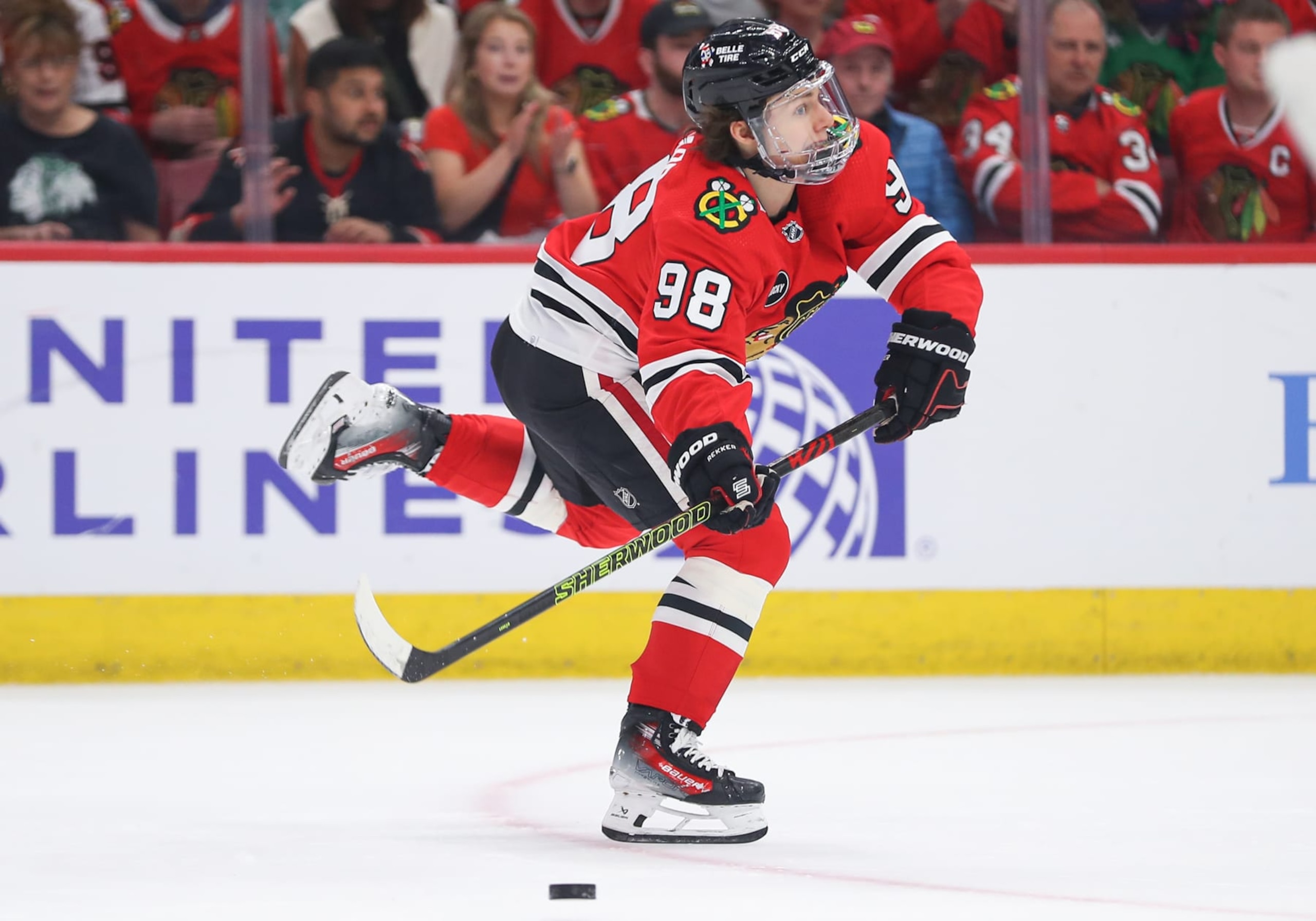 CHICAGO, IL - APRIL 14: Connor Bedard #98 of the Chicago Blackhawks passes the puck during the first period against the Carolina Hurricanes at the United Center on April 14, 2024 in Chicago, Illinois. (Photo by Melissa Tamez/Icon Sportswire via Getty Images)