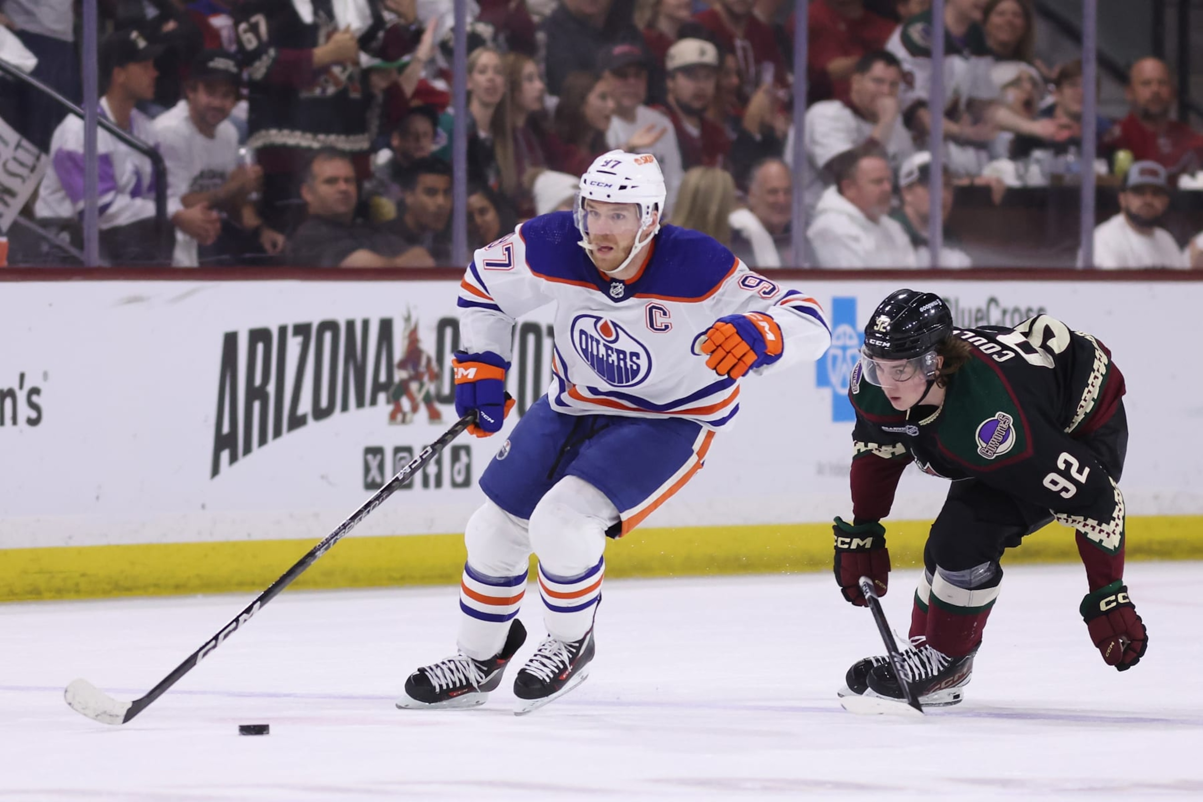 TEMPE, ARIZONA - APRIL 17: Connor McDavid #97 of the Edmonton Oilers skates with the puck ahead of Logan Cooley #92 of the Arizona Coyotes during the first period of the NHL game at Mullett Arena on April 17, 2024 in Tempe, Arizona. (Photo by Christian Petersen/Getty Images) TEMPE, ARIZONA - APRIL 17: Connor McDavid #97 of the Edmonton Oilers skates with the puck ahead of Logan Cooley #92 of the Arizona Coyotes during the first period of the NHL game at Mullett Arena on April 17, 2024 in Tempe, Arizona. (Photo by Christian Petersen/Getty Images)