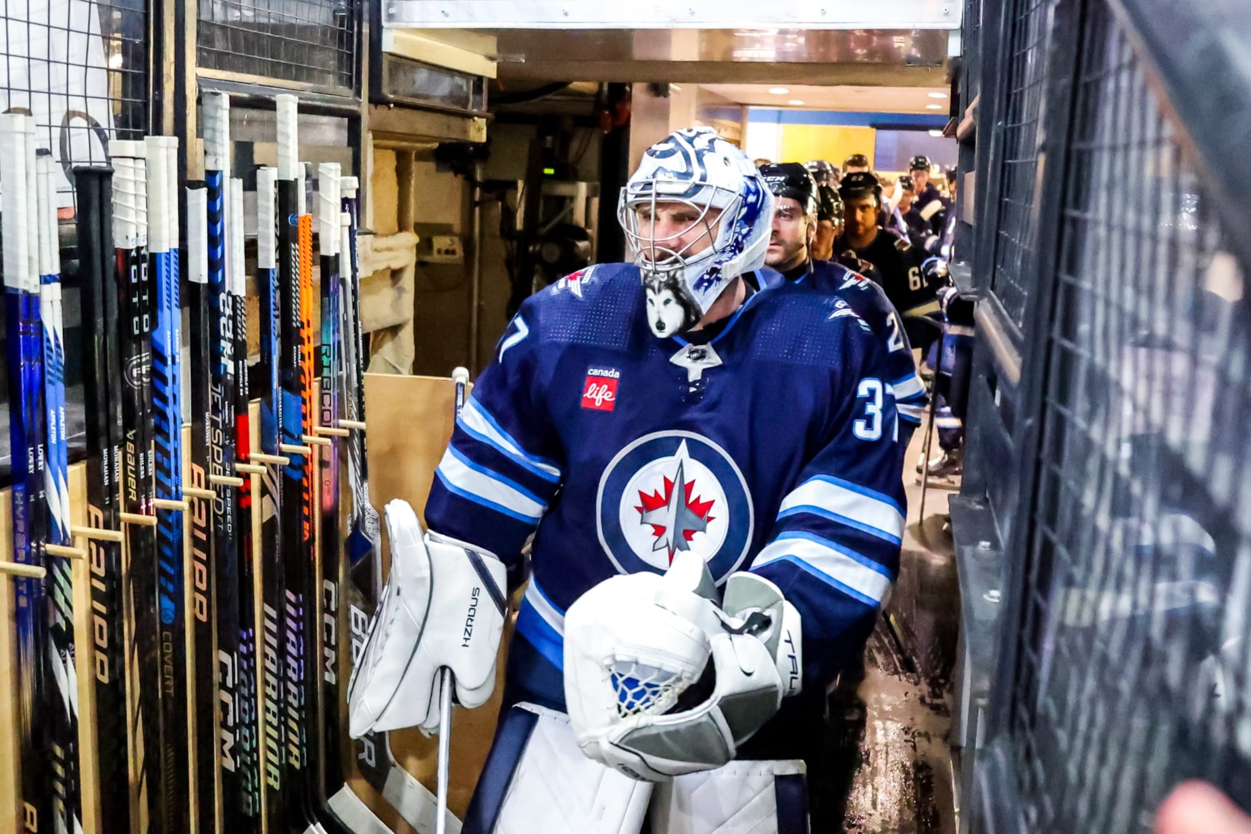 WINNIPEG, CANADA - APRIL 16: Goaltender Connor Hellebuyck #37 of the Winnipeg Jets leads teammates to the ice for the pre-game warm up prior to NHL action against the Seattle Kraken at the Canada Life Centre on April 16, 2024 in Winnipeg, Manitoba, Canada. (Photo by Jonathan Kozub/NHLI via Getty Images)