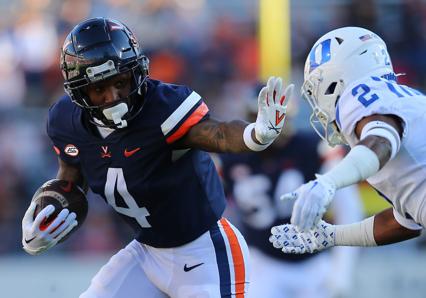 CHARLOTTESVILLE, VA - NOVEMBER 18: Virginia Cavaliers wide receiver Malik Washington (4) hauls in a pass then rushes up field while attempting to elude Duke Blue Devils defensive back Jaylen Stinson (2) during a college football game between the Duke Blue Devils and the Virginia Cavaliers on November 18, 2023, at Scott Stadium in Charlottesville, VA. (Photo by Lee Coleman/Icon Sportswire via Getty Images)
