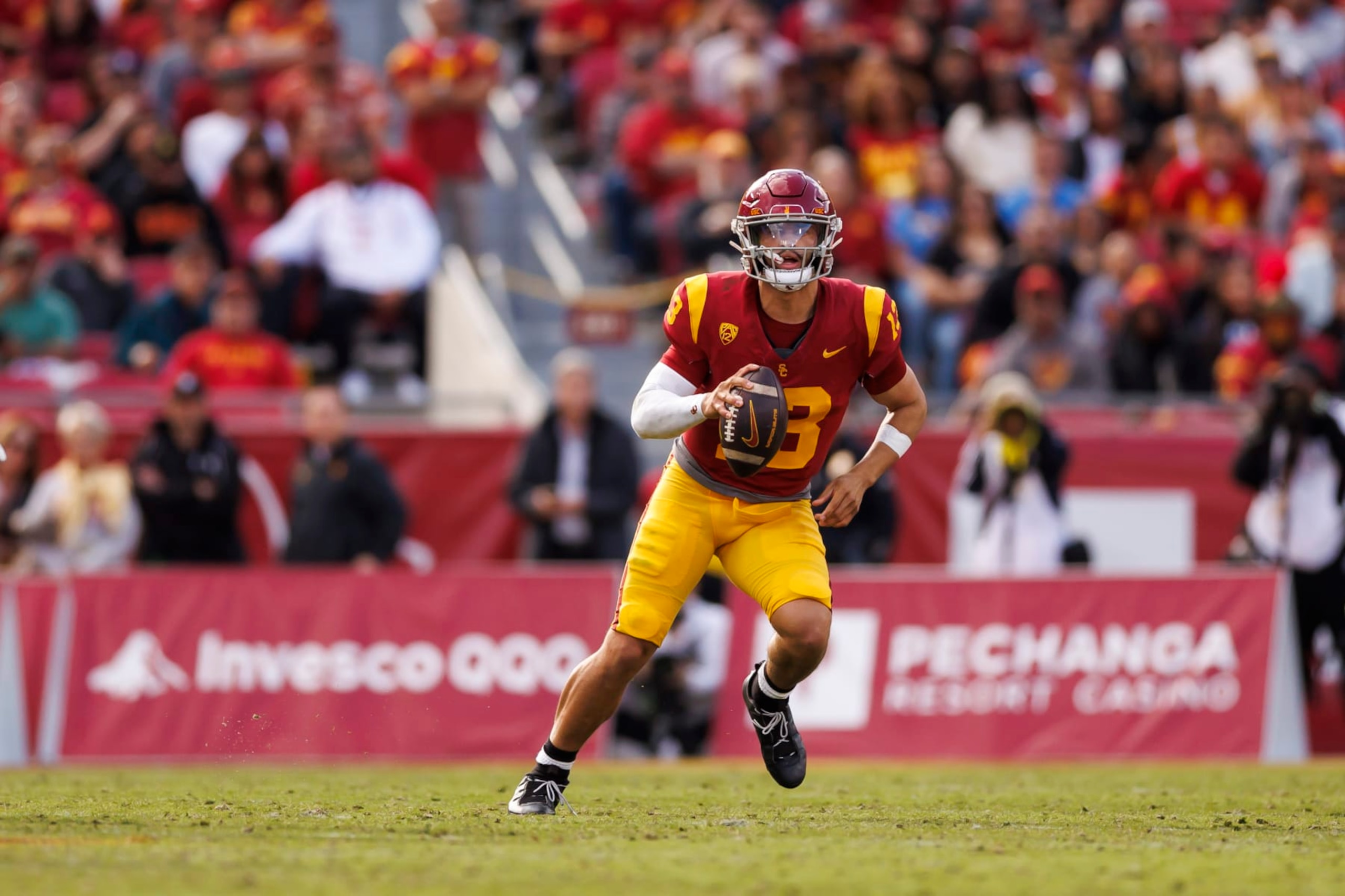 LOS ANGELES, CALIFORNIA - NOVEMBER 18: Caleb Williams #13 of the USC Trojans looks to throw a pass as he scrambles during the first half of a game against the UCLA Bruins at United Airlines Field at the Los Angeles Memorial Coliseum on November 18, 2023 in Los Angeles, California. (Photo by Ryan Kang/Getty Images)