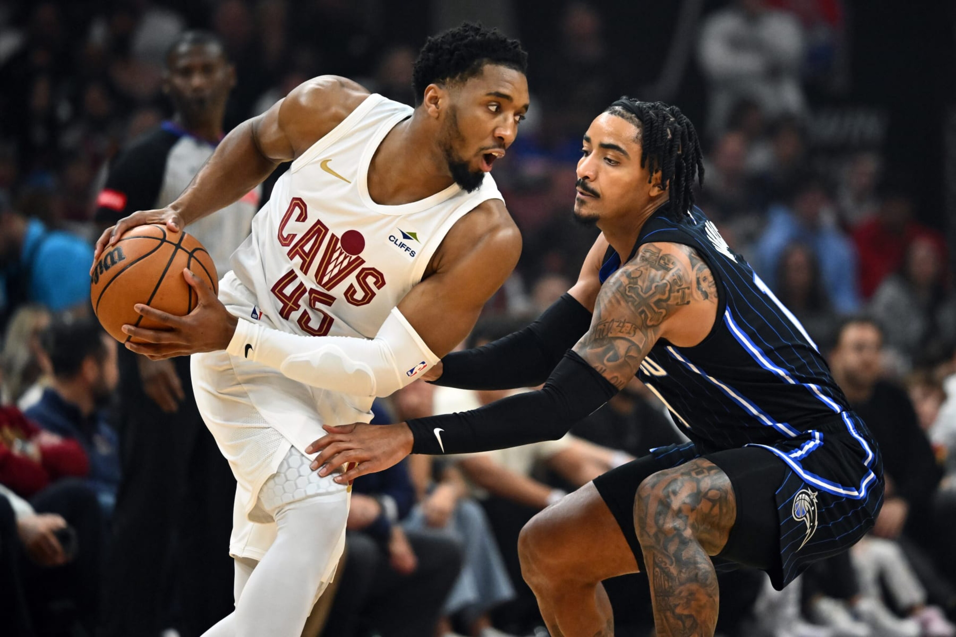CLEVELAND, OHIO - APRIL 20: Donovan Mitchell #45 of the Cleveland Cavaliers looks for a pass while under pressure from Gary Harris #14 of the Orlando Magic during the first quarter game one of the Eastern Conference First Round Playoffs at Rocket Mortgage Fieldhouse on April 20, 2024 in Cleveland, Ohio. NOTE TO USER: User expressly acknowledges and agrees that, by downloading and or using this photograph, User is consenting to the terms and conditions of the Getty Images License Agreement. (Photo by Jason Miller/Getty Images)