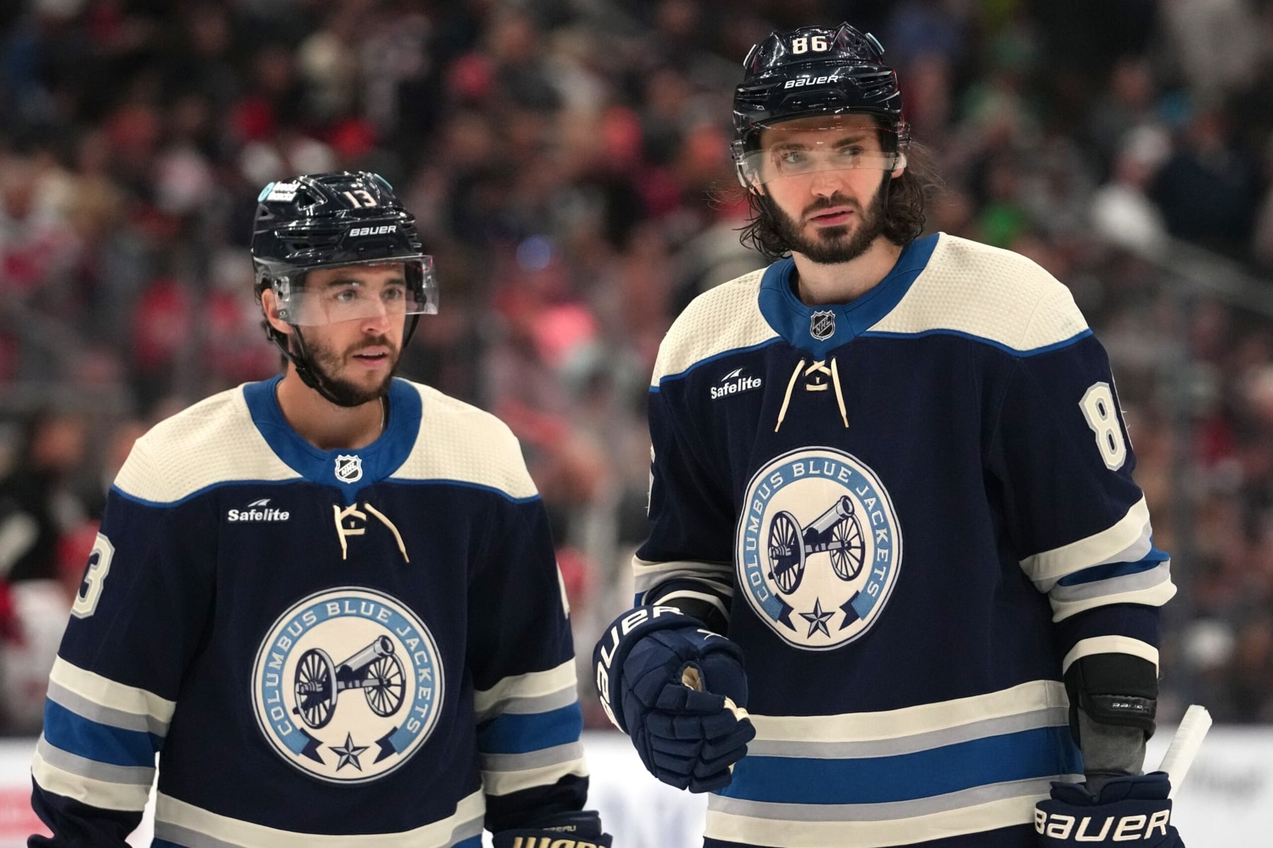 COLUMBUS, OHIO - APRIL 16: Johnny Gaudreau #13 and Kirill Marchenko #86 of the Columbus Blue Jackets takes a break during a stoppage in play against the Carolina Hurricanes at Nationwide Arena on April 16, 2024 in Columbus, Ohio. (Photo by Jason Mowry/Getty Images)