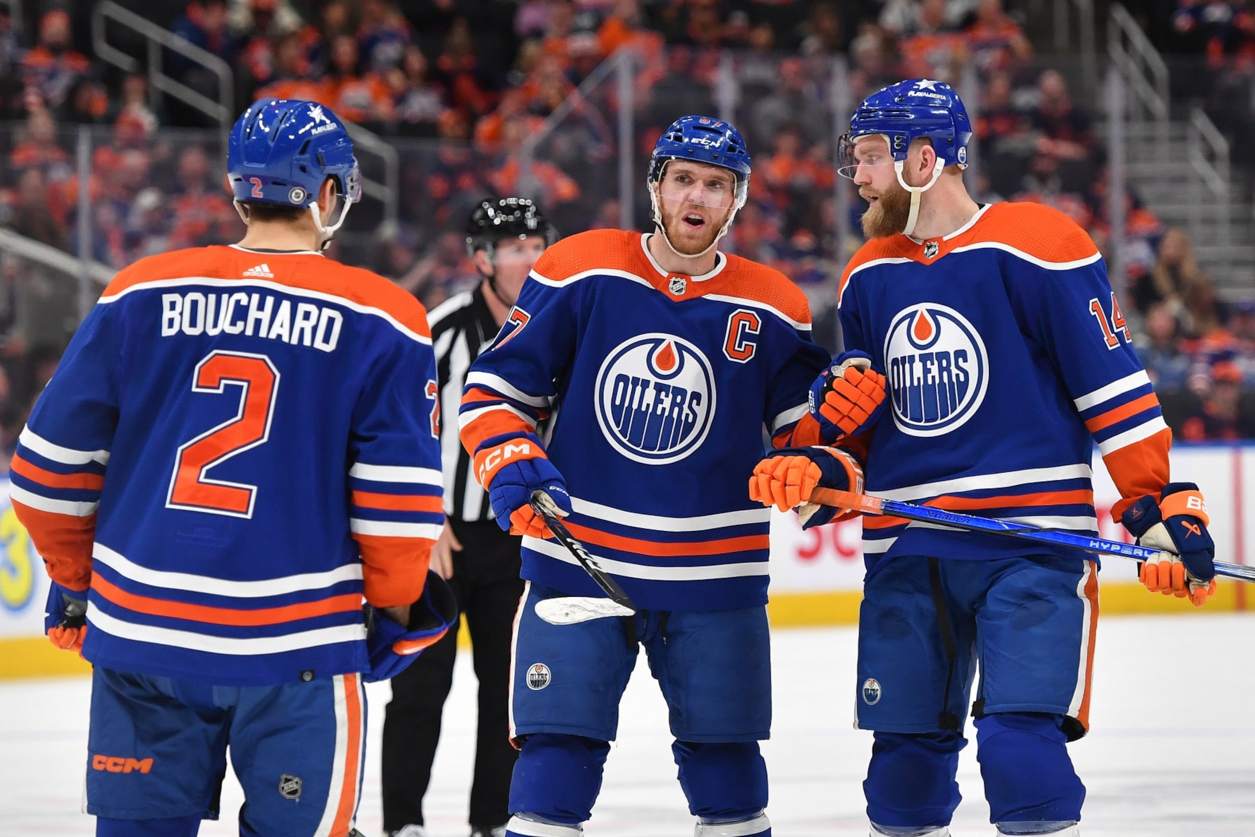 EDMONTON, CANADA - APRIL 15: Connor McDavid #97, Mattias Ekholm #14 and Evan Bouchard #2 of the Edmonton Oilers discuss the play during the game against the San Jose Sharks at Rogers Place on April 15, 2024, in Edmonton, Alberta, Canada. (Photo by Andy Devlin/NHLI via Getty Images)