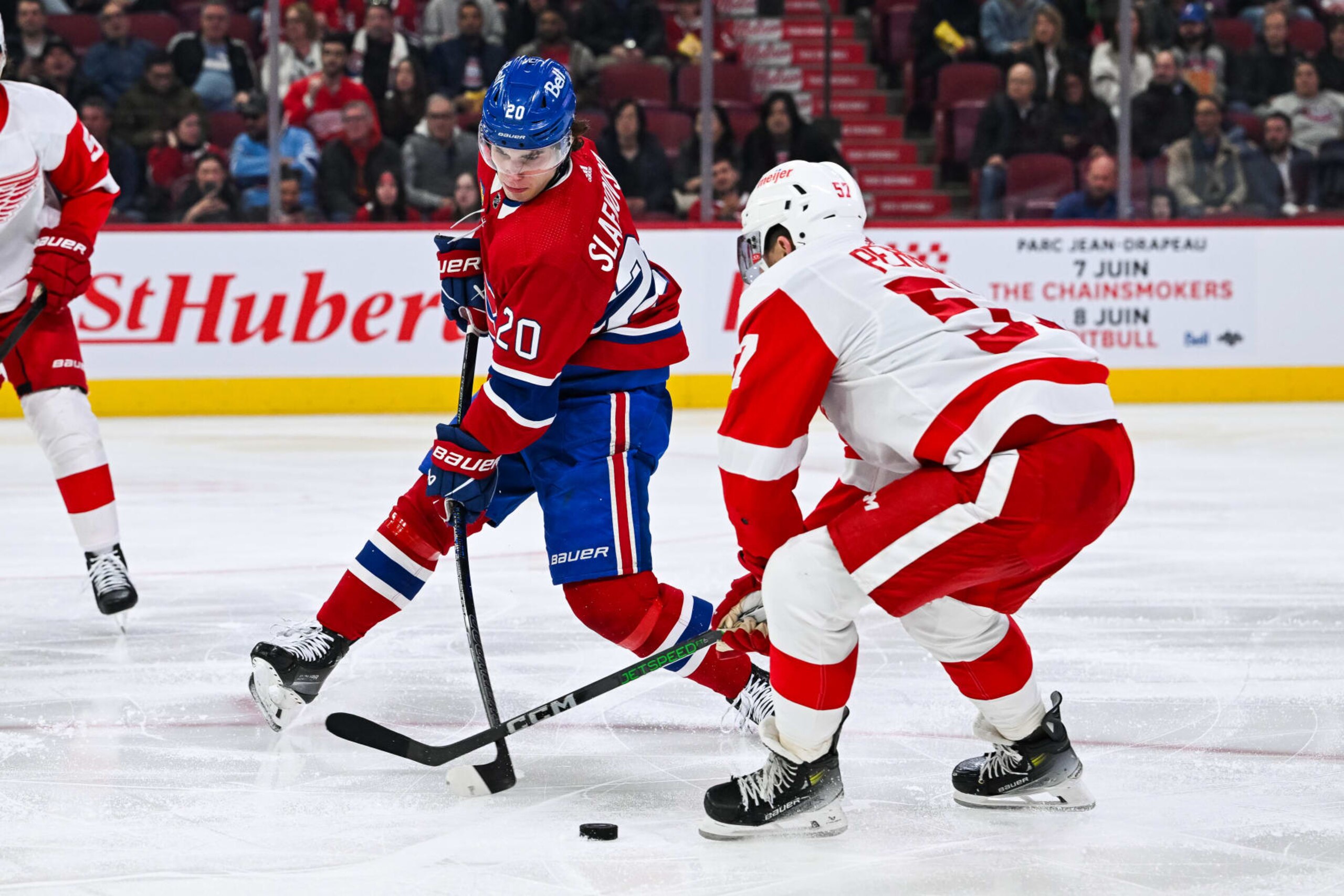 MONTREAL, QC - APRIL 16: Detroit Red Wings left wing David Perron (57) defends the puck against Montreal Canadiens left wing Juraj Slafkovsky (20) during the Detroit Red Wings versus the Montreal Canadiens game on April 16, 2024, at Bell Centre in Montreal, QC (Photo by David Kirouac/Icon Sportswire via Getty Images)