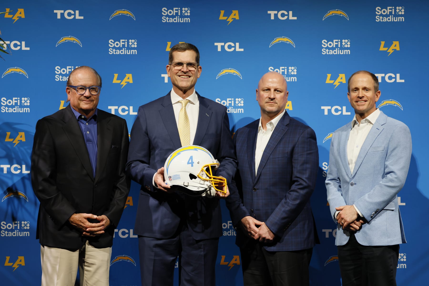 Inglewood, CA - February 01: Chargers Owner and Chairman of the Board Dean Spanos, left, President of Business Operations John Spanos, right, and Chargers new general manager Joe Hortiz, second from right, pose with new Los Angeles Chargers Head Coach Jim Harbaugh during an introductory press conference at YouTube Theater in Inglewood Thursday, Feb. 1, 2024. (Allen J. Schaben / Los Angeles Times via Getty Images)