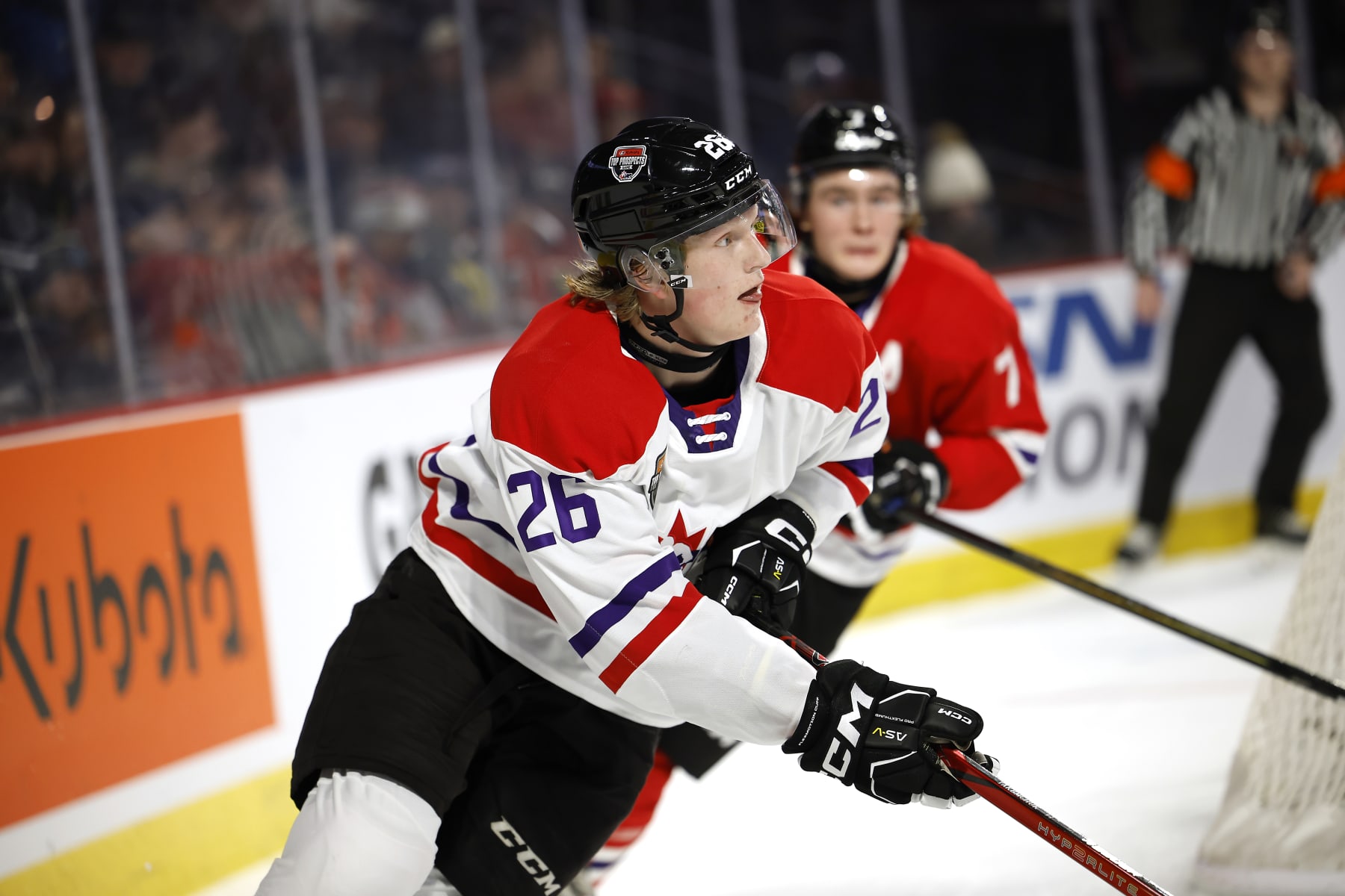 MONCTON, CANADA - JANUARY 24:Carter Yakemchuk #26 of Team White skates the puck from behind the net with Maxim Massé #7 of Team Red in pursuit during the second period of the 2024 Kubota CHL Top Prospects Game at Avenir Centre on January 24, 2024 in Moncton, Canada. (Photo by Dale Preston/Getty Images)