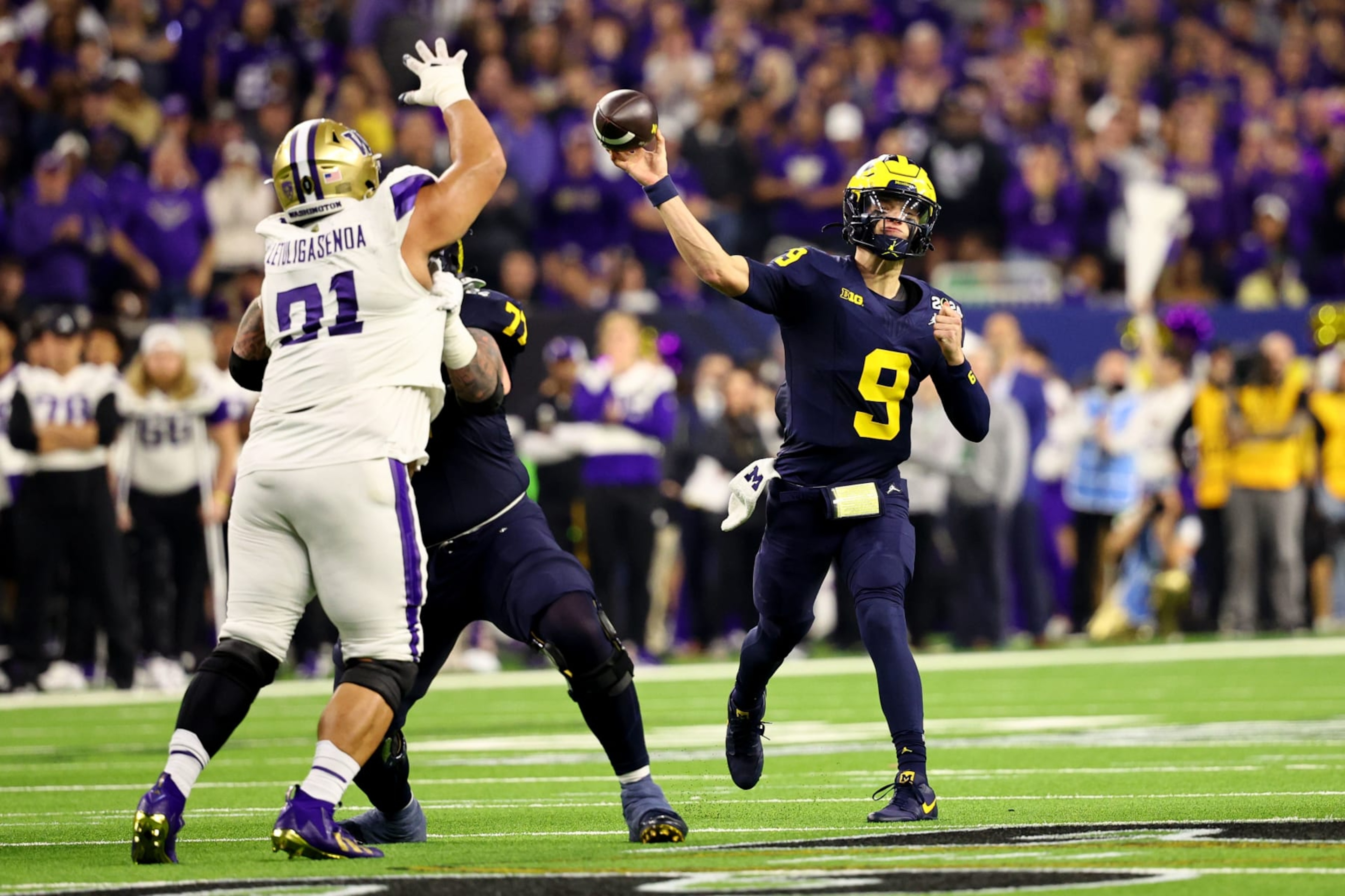 HOUSTON, TEXAS - JANUARY 8: J.J. McCarthy #9 of the Michigan Wolverines passes against the Washington Huskies during the 2024 CFP National Championship game at NRG Stadium on January 8, 2024 in Houston, Texas. (Photo by Jamie Schwaberow/Getty Images)