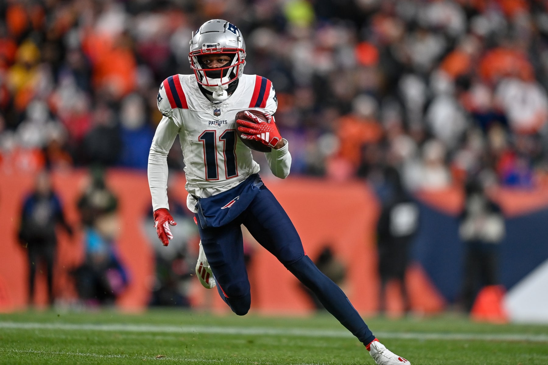 DENVER, COLORADO - DECEMBER 24:  Tyquan Thornton #11 of the New England Patriots runs after a catch against the Denver Broncos in the first half of a game at Empower Field at Mile High on December 24, 2023 in Denver, Colorado. (Photo by Dustin Bradford/Getty Images)