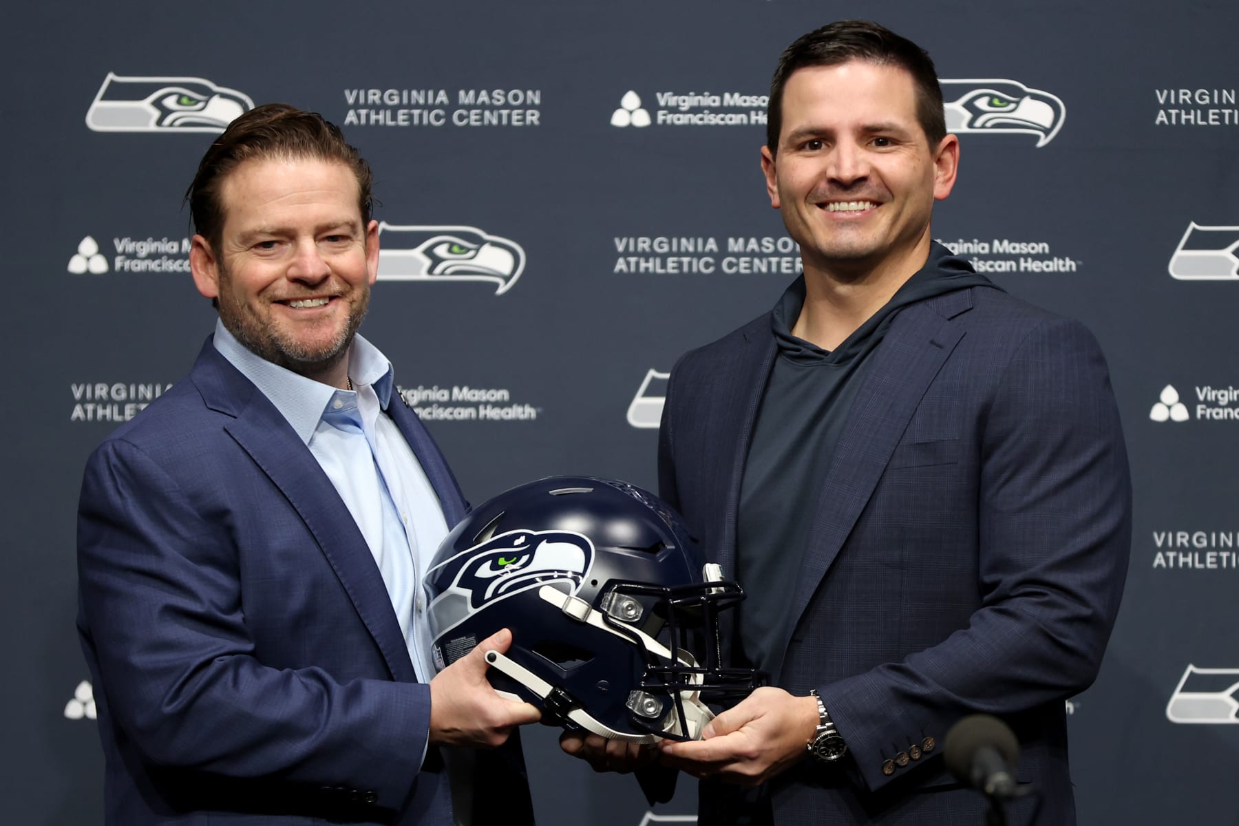 RENTON, WASHINGTON - FEBRUARY 01: John Schneider, general manager of the Seattle Seahawks, poses with Mike Macdonald as Macdonald is announced as the new Seattle Seahawks head coach at Virginia Mason Athletic Center on February 01, 2024 in Renton, Washington. (Photo by Steph Chambers/Getty Images)