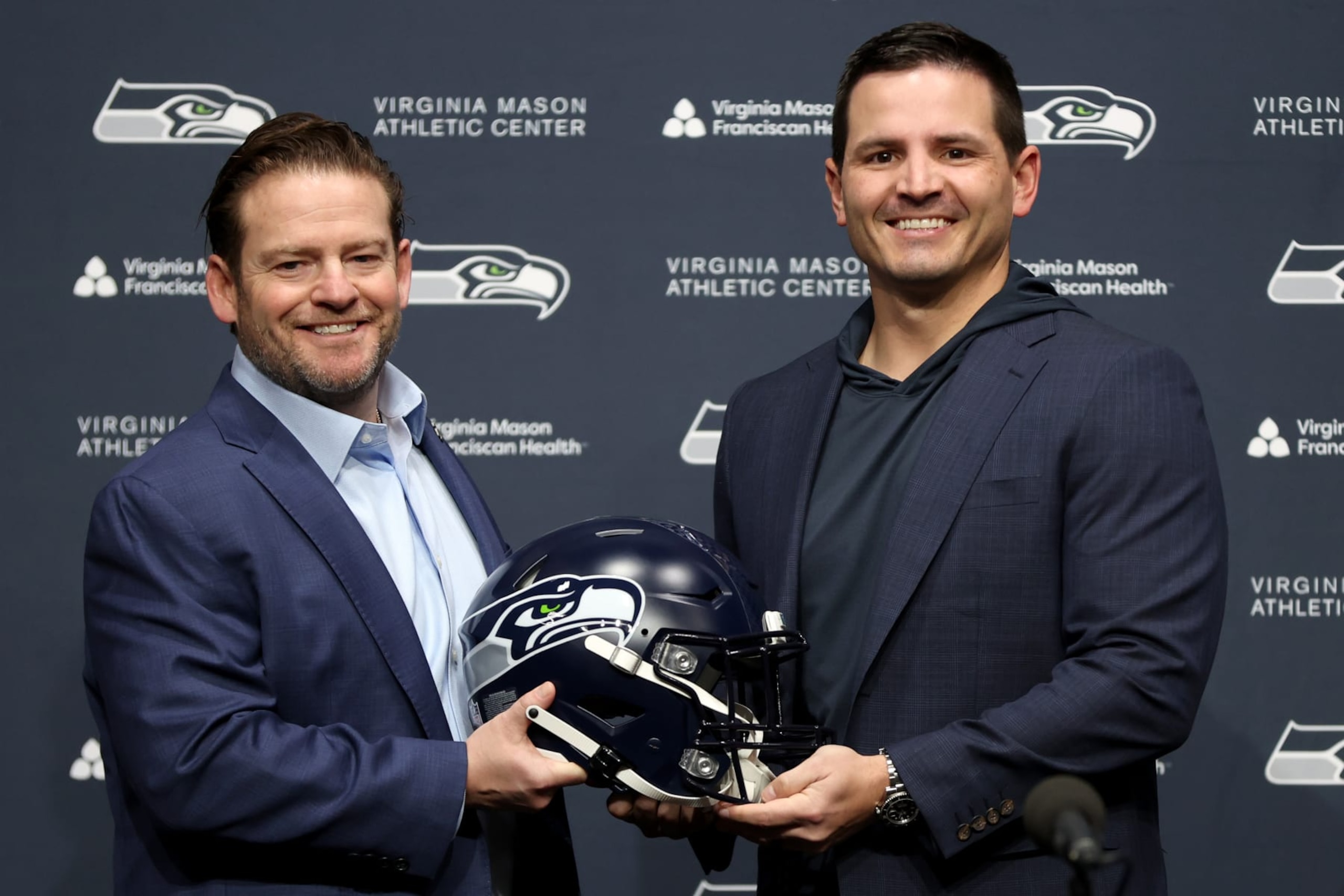 RENTON, WASHINGTON - FEBRUARY 01: John Schneider, general manager of the Seattle Seahawks, poses with Mike Macdonald as Macdonald is announced as the new Seattle Seahawks head coach at Virginia Mason Athletic Center on February 01, 2024 in Renton, Washington. (Photo by Steph Chambers/Getty Images) RENTON, WASHINGTON - FEBRUARY 01: John Schneider, general manager of the Seattle Seahawks, poses with Mike Macdonald as Macdonald is announced as the new Seattle Seahawks head coach at Virginia Mason Athletic Center on February 01, 2024 in Renton, Washington. (Photo by Steph Chambers/Getty Images)