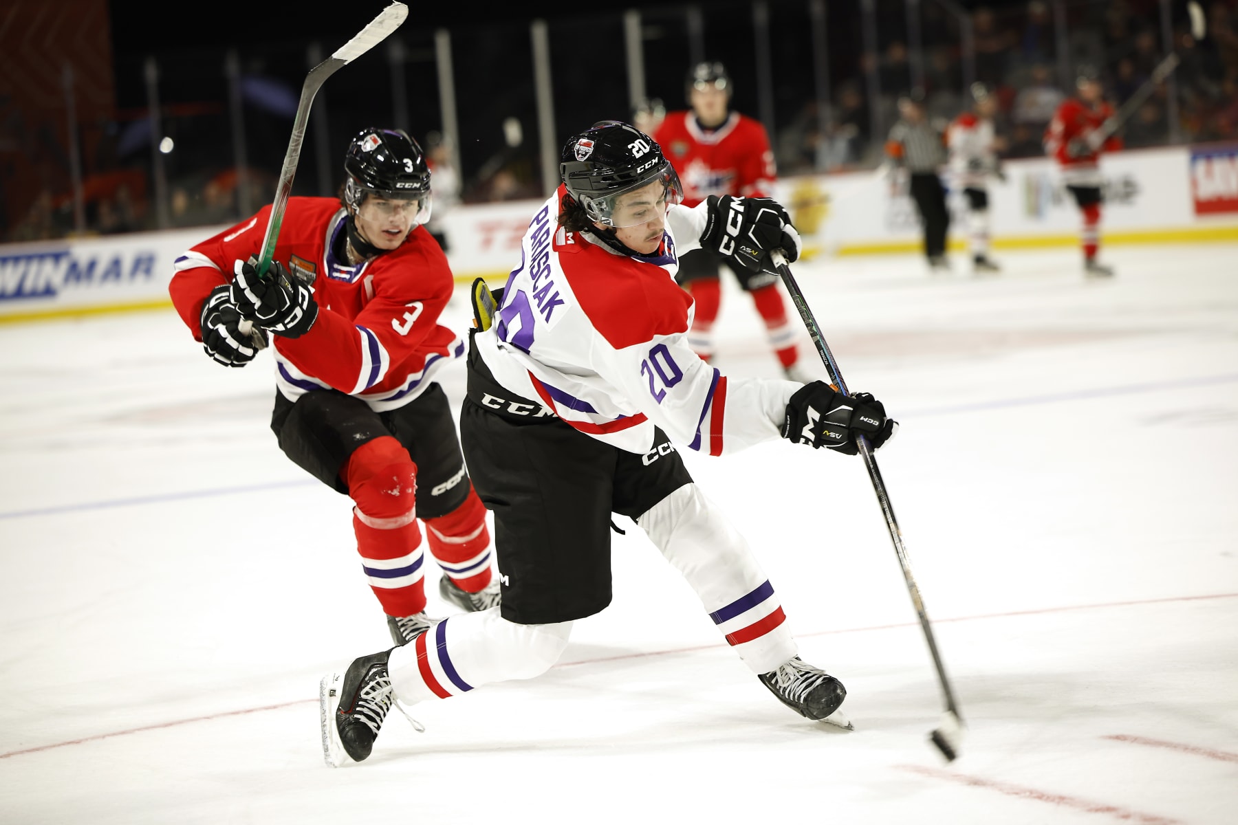 MONCTON, CANADA - JANUARY 24:Terik Parascak #20 of Team White takes a shot on goal with Sam Dickinson #3 of Team Red defending during the third period of the 2024 Kubota CHL Top Prospects Game at Avenir Centre on January 24, 2024 in Moncton, Canada. (Photo by Dale Preston/Getty Images)
