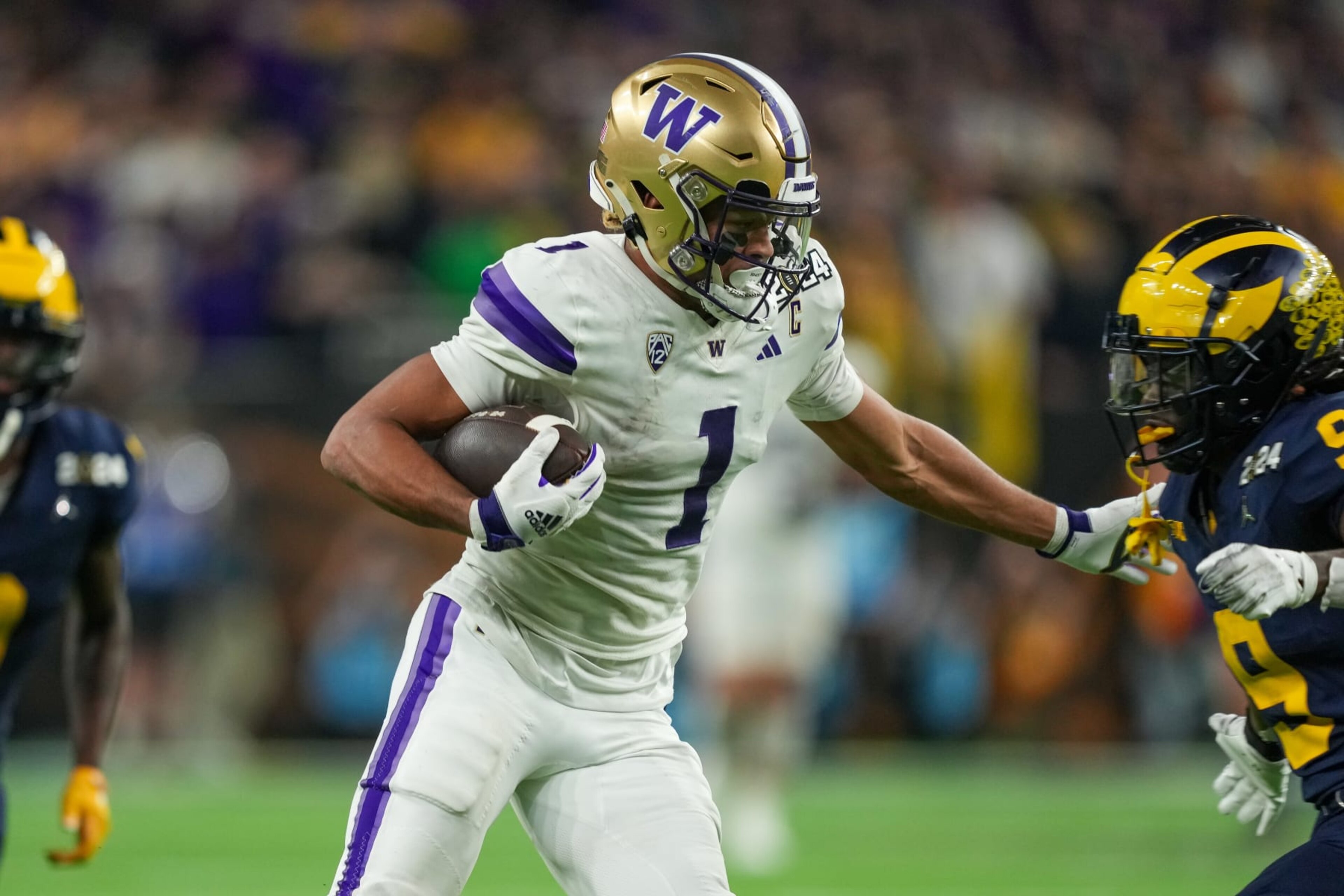 HOUSTON, TX - JANUARY 08: Washington Huskies wide receiver Rome Odunze (1) runs the ball during the CFP National Championship game between the Michigan Wolverines and Washington Huskies on January 8, 2024 at NRG Stadium in Houston, Texas. (Photo by Daniel Dunn/Icon Sportswire via Getty Images)