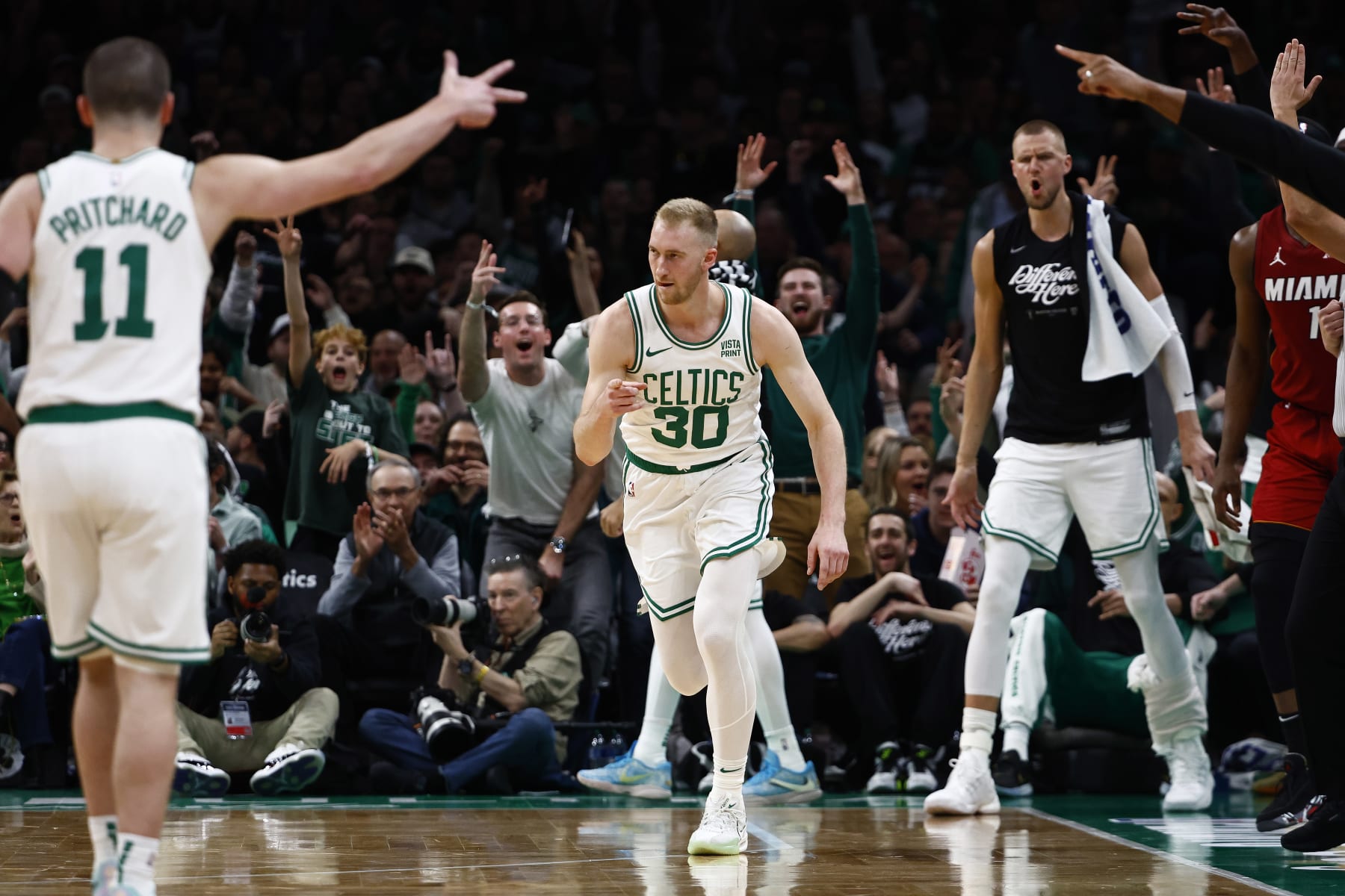 BOSTON, MA - APRIL 21: Sam Hauser #30 of the Boston Celtics points to teammate Payton Pritchard #11 after making a three point basket against the Miami Heat during the first quarter of game one of the Eastern Conference First Round Playoffs at TD Garden on April 21, 2024 in Boston, Massachusetts. NOTE TO USER: User expressly acknowledges and agrees that, by downloading and/or using this Photograph, user is consenting to the terms and conditions of the Getty Images License Agreement. (Photo By Winslow Townson/Getty Images) BOSTON, MA - APRIL 21: Sam Hauser #30 of the Boston Celtics points to teammate Payton Pritchard #11 after making a three point basket against the Miami Heat during the first quarter of game one of the Eastern Conference First Round Playoffs at TD Garden on April 21, 2024 in Boston, Massachusetts. NOTE TO USER: User expressly acknowledges and agrees that, by downloading and/or using this Photograph, user is consenting to the terms and conditions of the Getty Images License Agreement. (Photo By Winslow Townson/Getty Images)