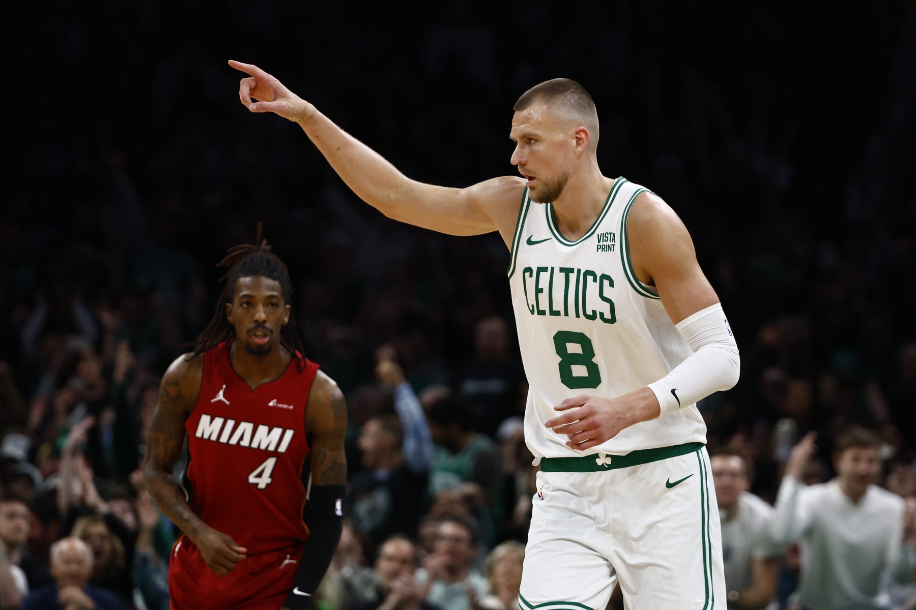 BOSTON, MA - APRIL 21: Kristaps Porzingis #8 of the Boston Celtics points to a teammate after making a three point basket as Delon Wright #4 of the Miami Heat looks on during the first quarter of game one of the Eastern Conference First Round Playoffs at TD Garden on April 21, 2024 in Boston, Massachusetts. NOTE TO USER: User expressly acknowledges and agrees that, by downloading and/or using this Photograph, user is consenting to the terms and conditions of the Getty Images License Agreement. (Photo By Winslow Townson/Getty Images) BOSTON, MA - APRIL 21: Kristaps Porzingis #8 of the Boston Celtics points to a teammate after making a three point basket as Delon Wright #4 of the Miami Heat looks on during the first quarter of game one of the Eastern Conference First Round Playoffs at TD Garden on April 21, 2024 in Boston, Massachusetts. NOTE TO USER: User expressly acknowledges and agrees that, by downloading and/or using this Photograph, user is consenting to the terms and conditions of the Getty Images License Agreement. (Photo By Winslow Townson/Getty Images)