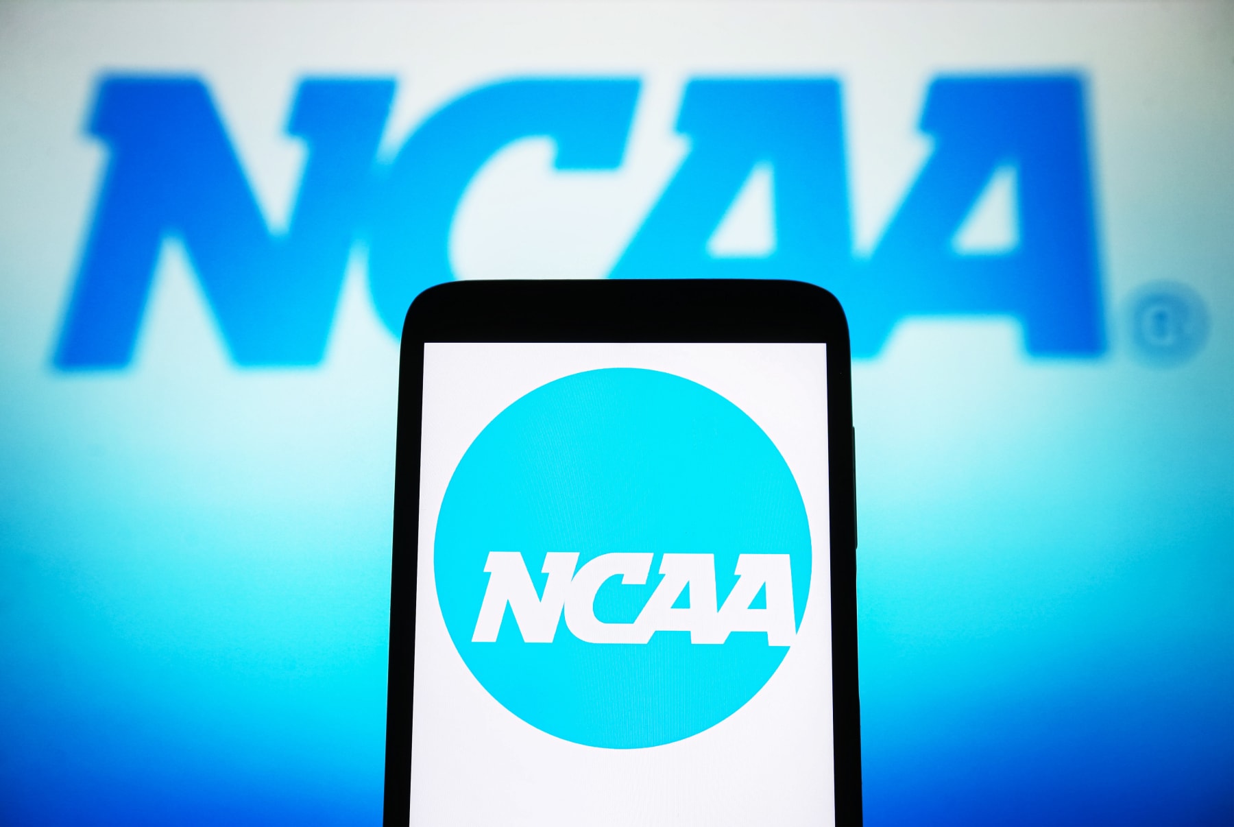 UKRAINE - 2024/04/09: In this photo illustration, a National Collegiate Athletic Association (NCAA) logo is seen on a smartphone and a pc screen. (Photo Illustration by Pavlo Gonchar/SOPA Images/LightRocket via Getty Images)