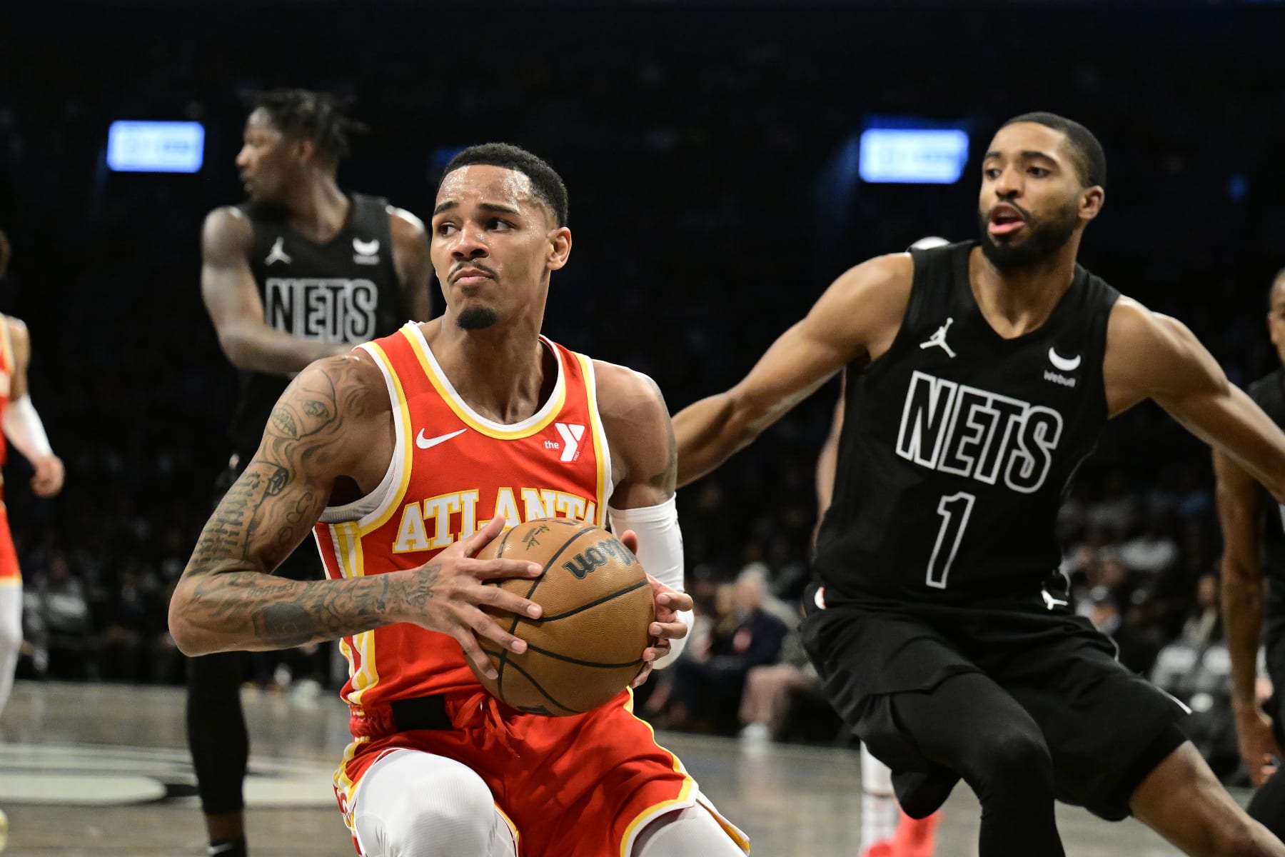 NEW YORK, NEW YORK - FEBRUARY 29:  Dejounte Murray #5 of the Atlanta Hawks is defended by Mikal Bridges #1 of the Brooklyn Nets during the game at Barclays Center on February 29, 2024 in New York City. NOTE TO USER: User expressly acknowledges and agrees that, by downloading and or using this photograph, User is consenting to the terms and conditions of the Getty Images License Agreement. (Photo by Steven Ryan/Getty Images)