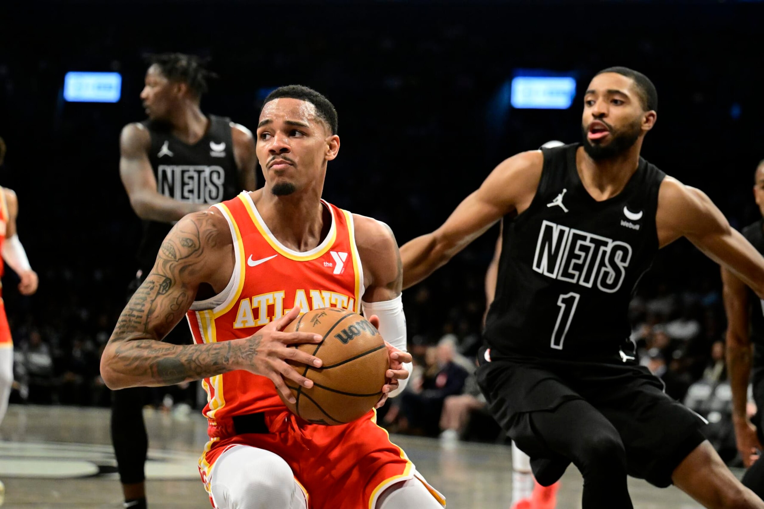 NEW YORK, NEW YORK - FEBRUARY 29:  Dejounte Murray #5 of the Atlanta Hawks is defended by Mikal Bridges #1 of the Brooklyn Nets during the game at Barclays Center on February 29, 2024 in New York City. NOTE TO USER: User expressly acknowledges and agrees that, by downloading and or using this photograph, User is consenting to the terms and conditions of the Getty Images License Agreement. (Photo by Steven Ryan/Getty Images)