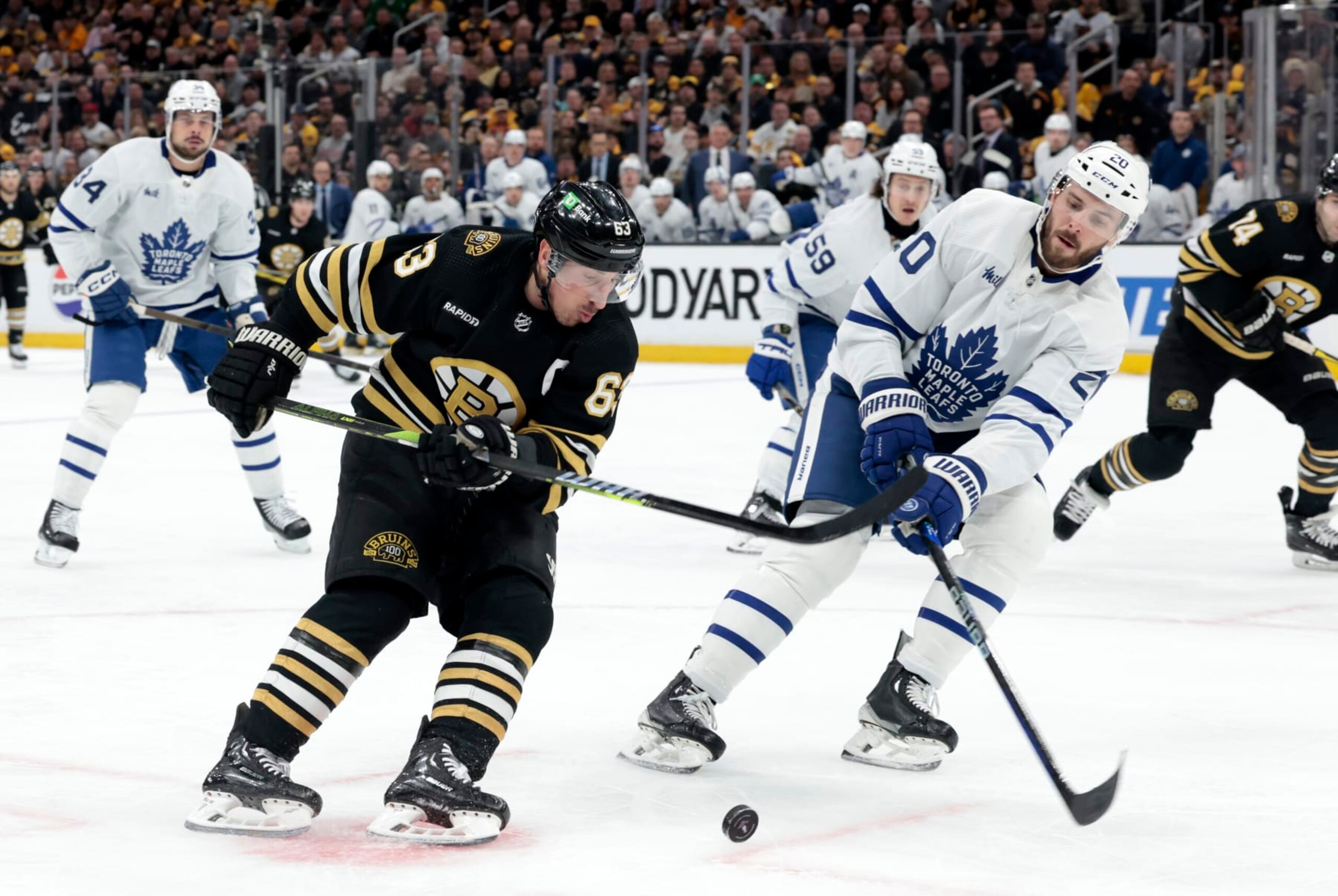 BOSTON, MA - APRIL 22: Boston Bruins left wing Brad Marchand (63) drives past Toronto Maple Leafs defenseman Joel Edmundson (20) during Game 2 of the Eastern Conference First Round playoffs between the Boston Bruins and the Toronto Maple Leafs on April 22, 2024, at TD Garden in Boston, Massachusetts. (Photo by Fred Kfoury III/Icon Sportswire via Getty Images)